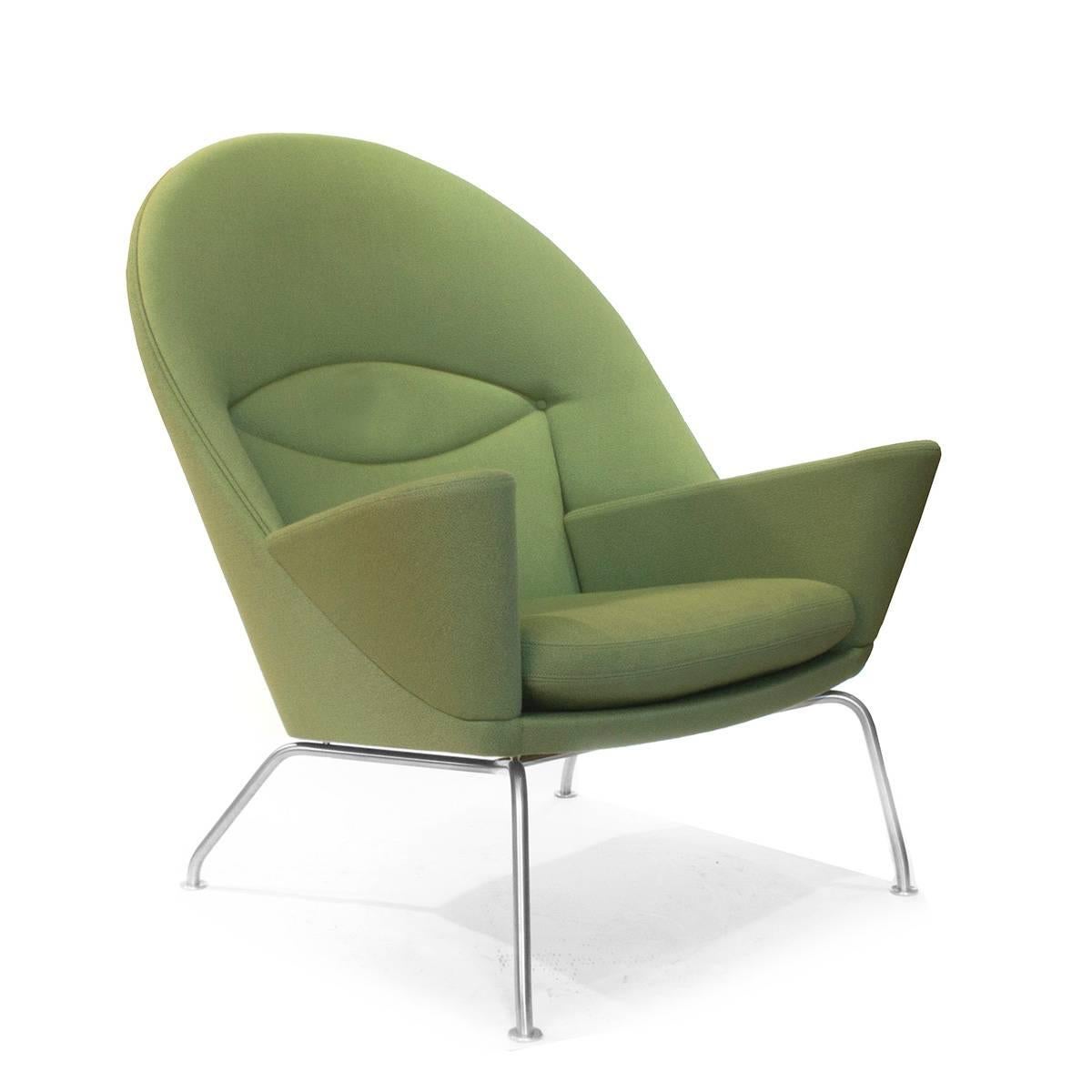 A sought-after and sculptural armchair designed by Hans J. Wegner in 1960 but not put into production until 2010. The chair is known as The Oculus. Oculus is Latin for eye and refers to the chair's curved back which forms an eye in the upholstery.