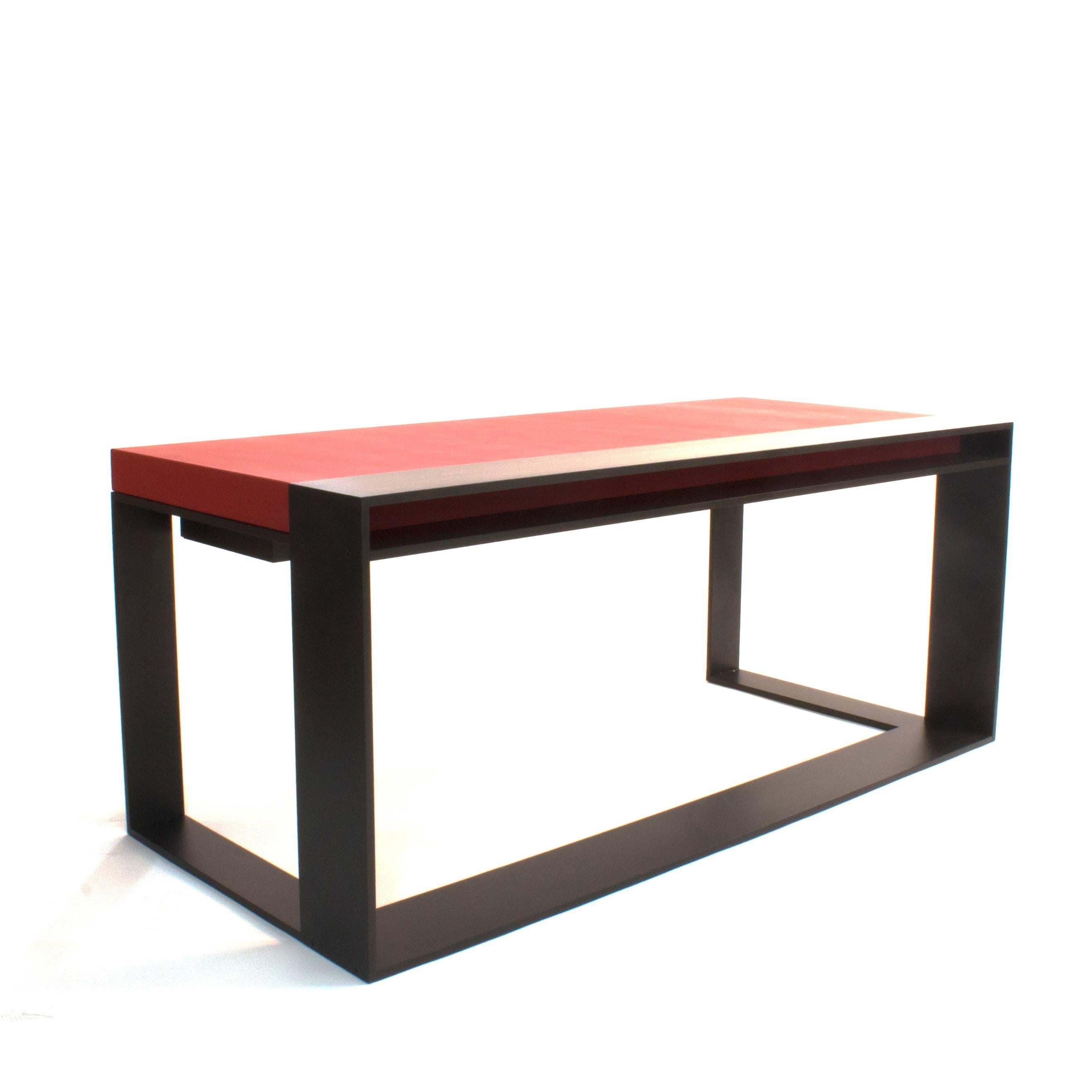 Desk with satin ebonized metal frame and top in CL leather. Leather has an embossed linear detail. Drawer on side includes built-in organizer.