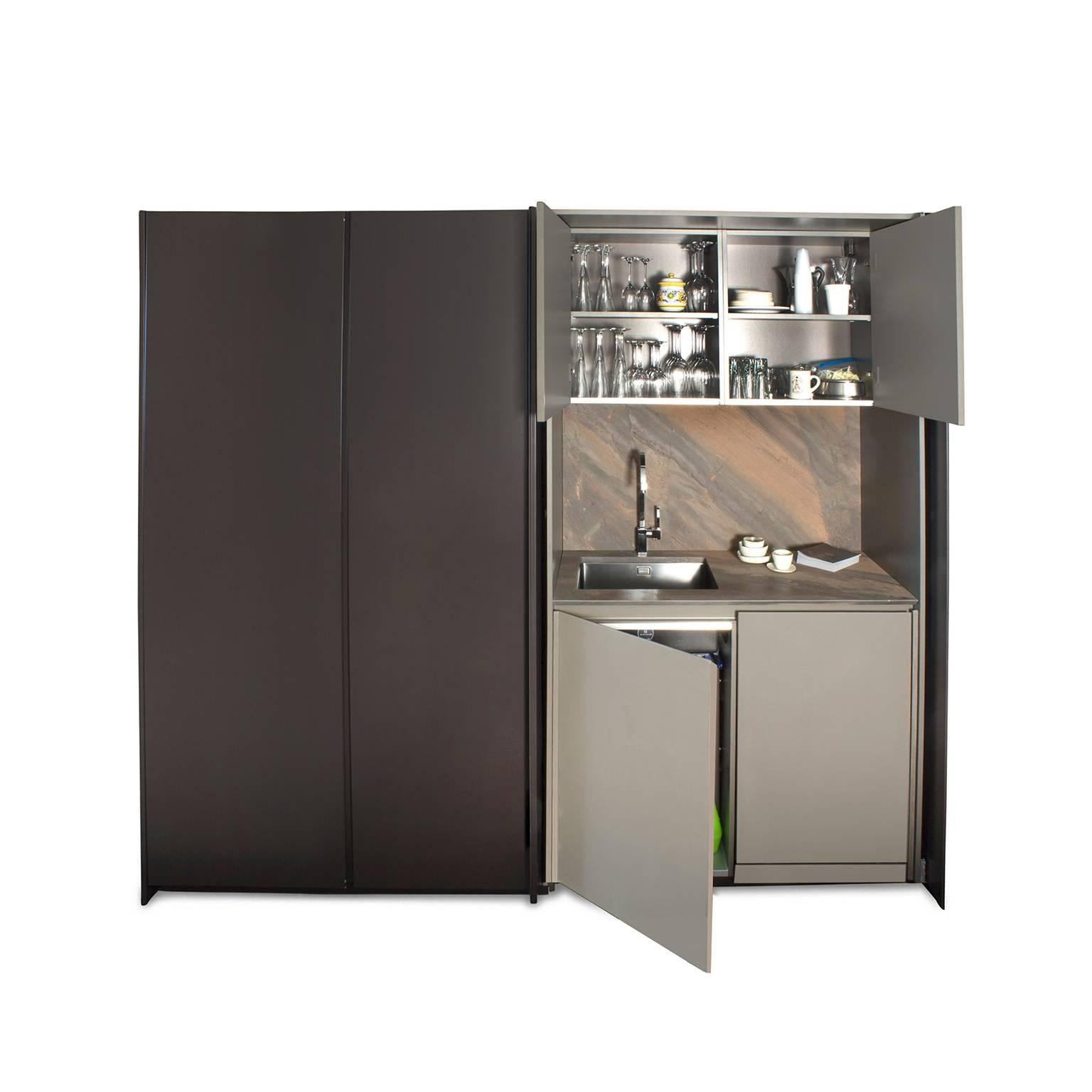 Viva is more than just a kitchen cabinet, it’s a program that goes beyond the traditional idea of kitchens. Pantry with retractable Hawa doors. Tall cabinets finish in Matte Brown Lacquer with pull-out chrome baskets. Double Ovens by Foster. Base