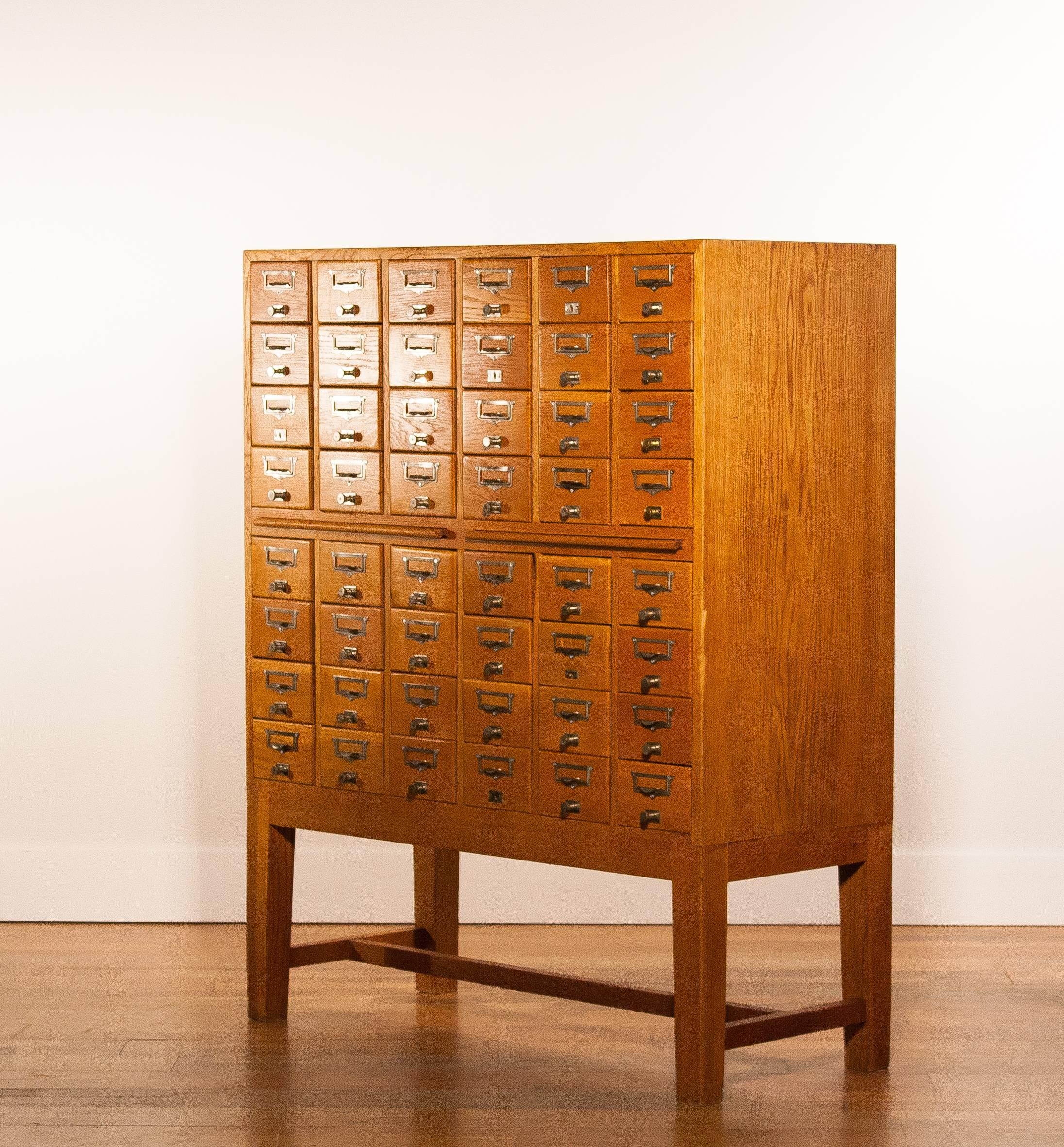 Beautiful oak file cabinet in fair condition.

The solid oak cabinet counters 48 drawers. All made of solid oak.

Also the cabinet has two extendable worksheets in oak.

Period: 1900-1940.

The dimensions are:
127 cm. height,
103 cm.