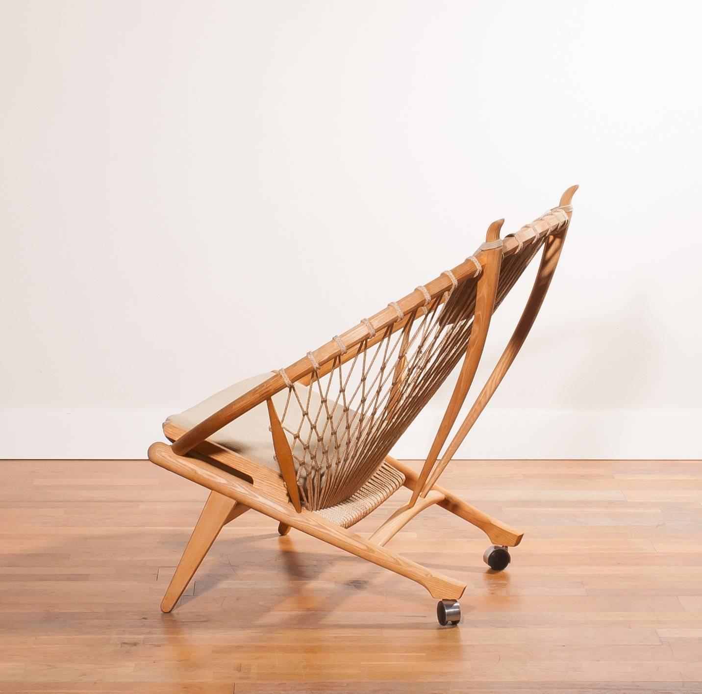 Very beautiful ' Circle ' PP130 chair designed by Hans J. Wegner for PP Möbler.
This fabulous chair is made of oak with a net of flags rope secured with steel clips.
Under the back legs are wheels and at the top of the backrest two handles, so