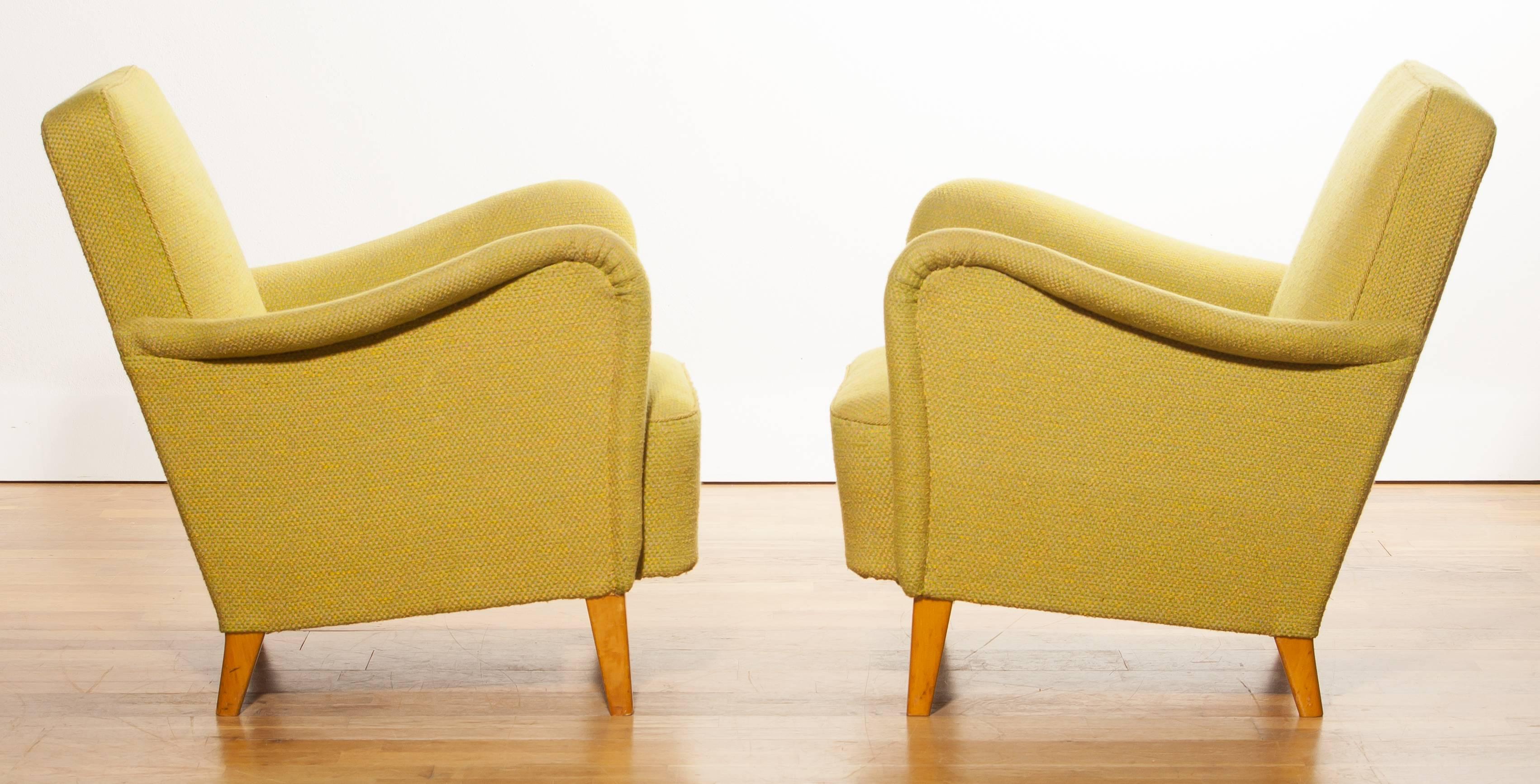 Early lounge chairs designed by Carl Malmsten for DUX. 
The seats have a DUX mattress spring system.
Original tag on the bottom. 
Later yellow-green fabric upholstery.
Period 1940s
Dimensions: H.73 cm, W.73 cm, D.74 cm, Sh 37 cm.