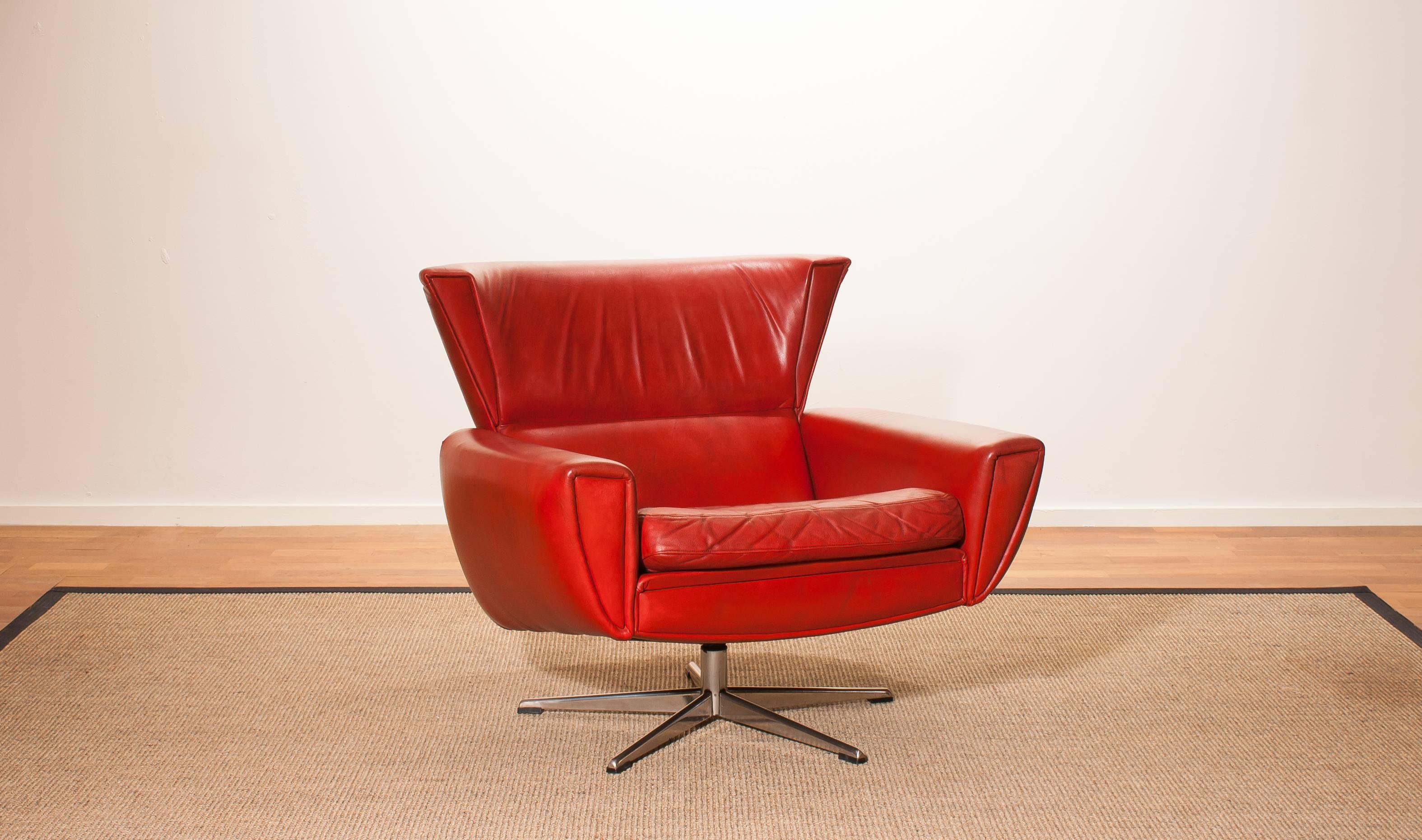 Beautiful lounge swivel club chair by Georg Thams for Lystager Industri Denmark.
This chair is upholstered with red leather on a steel swivel stand.
It is in a wonderful used condition.
Period 1970s
Dimensions: H 74 cm, W 84 cm, D 75 cm, Sh 41