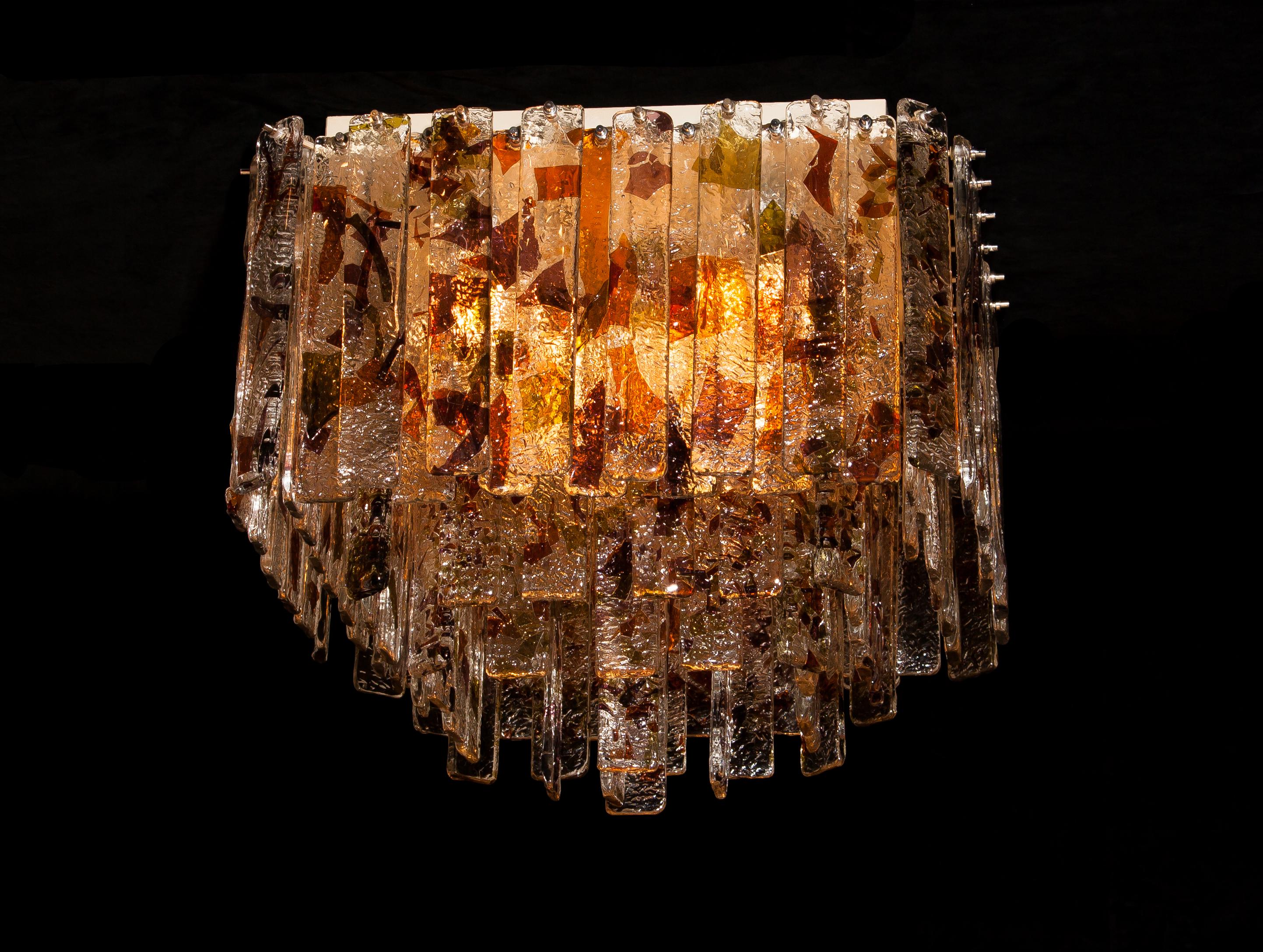Stunning Italian Mid-Century Modern squared ceiling lamp by Mazzega.
95 pieces of clear crystal elements measuring 28cm each.
The glass hangs on hooks and pins on to a white lacquered metal frame, as pictured.
The elements have three colors