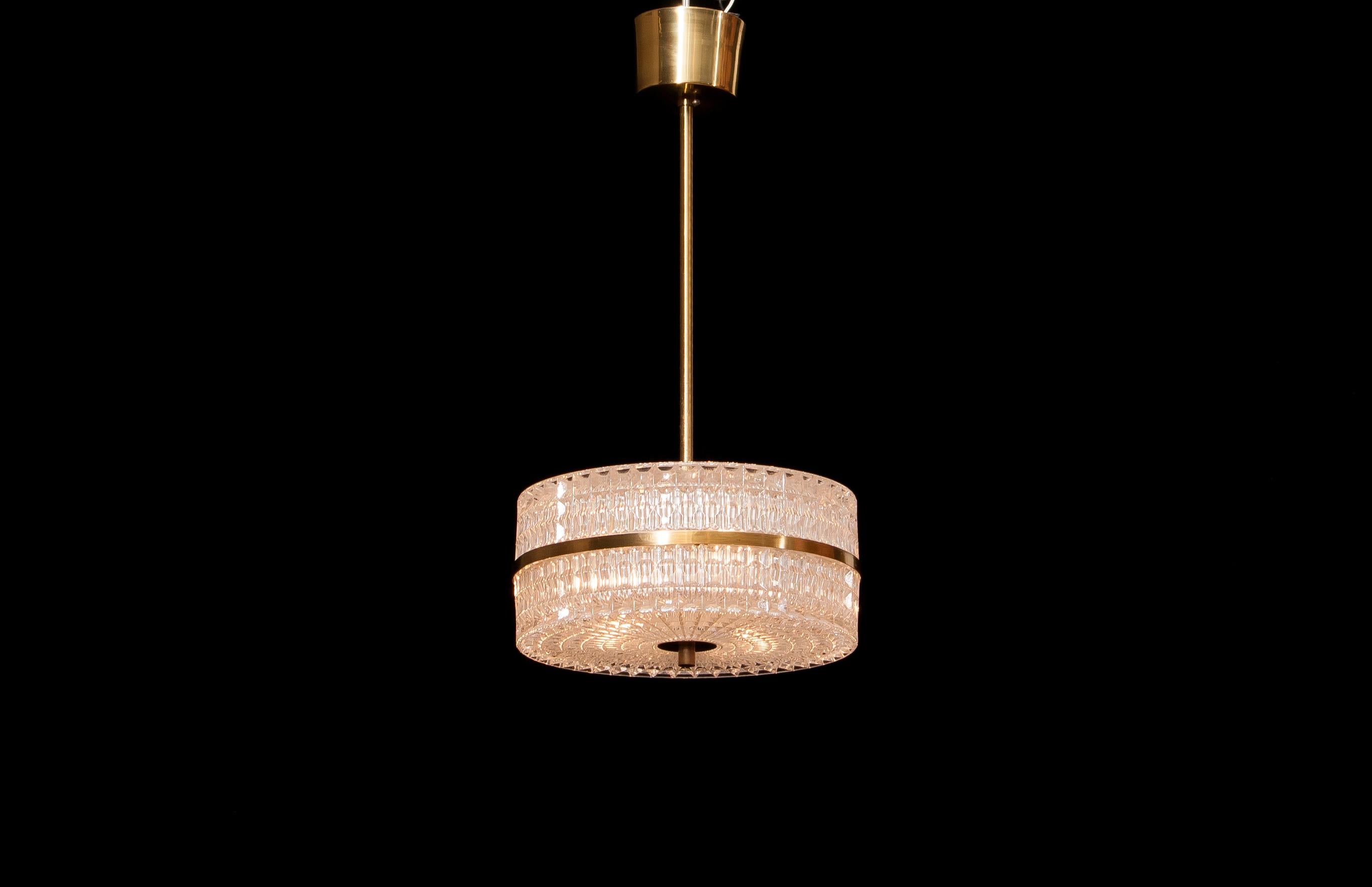 Beautiful ceiling lamp designed by Carl Fagerlund for Orrefors, Sweden.
The crystal glass with the brass details makes it a very nice combination.
It is in a wonderful working condition.
Period 1960s.
Dimensions: H 50 cm, ø 26 cm.