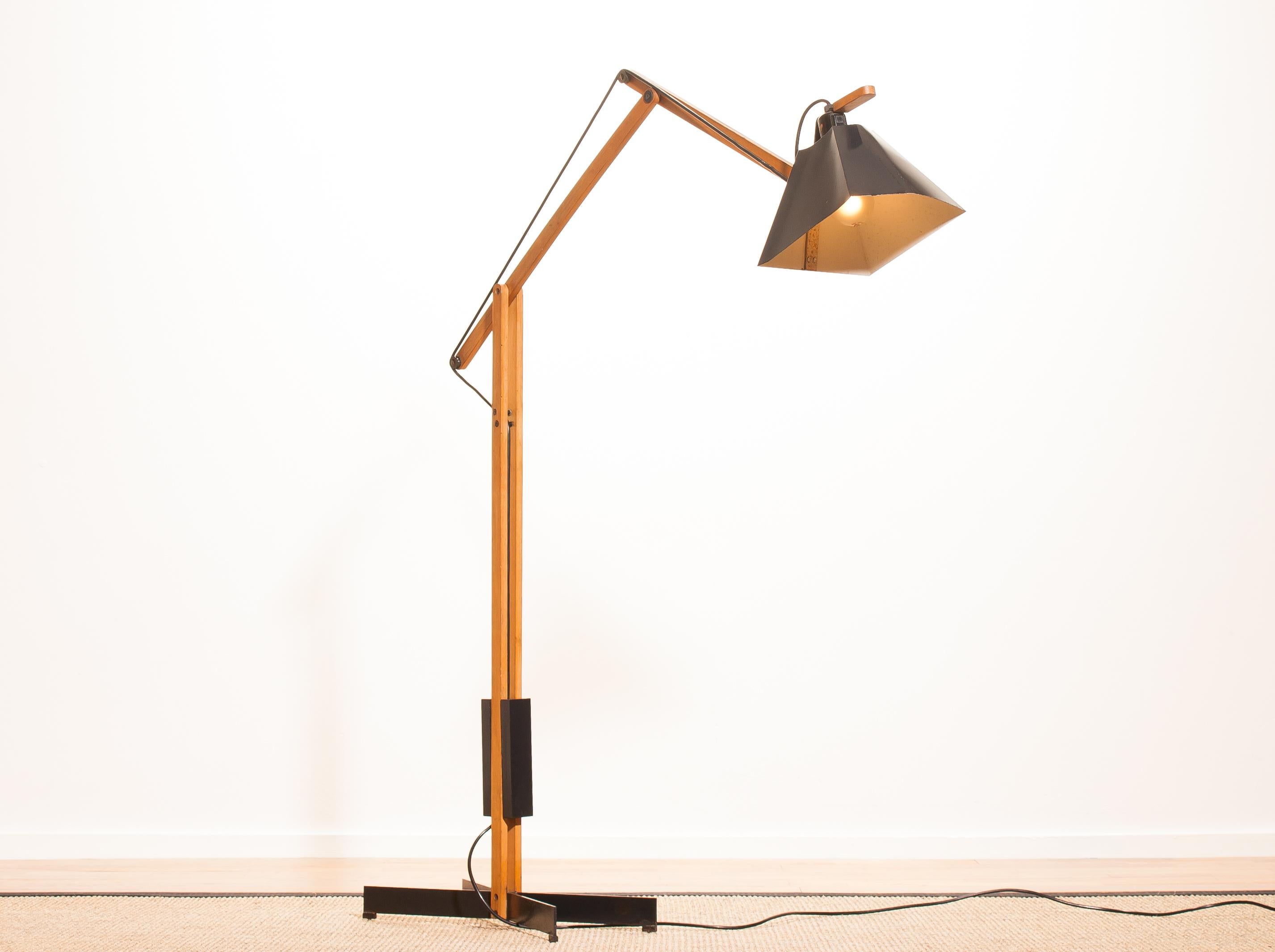 Magnificent rare floor lamp by Luxus, Sweden.
This lamp is adjustable by a counterbalance.
The stand is made of teak with a black lacquered shade.
It is labelled by Luxus and in a beautiful condition,
circa 1950s.
Dimensions: H 125 cm, D 90 cm,