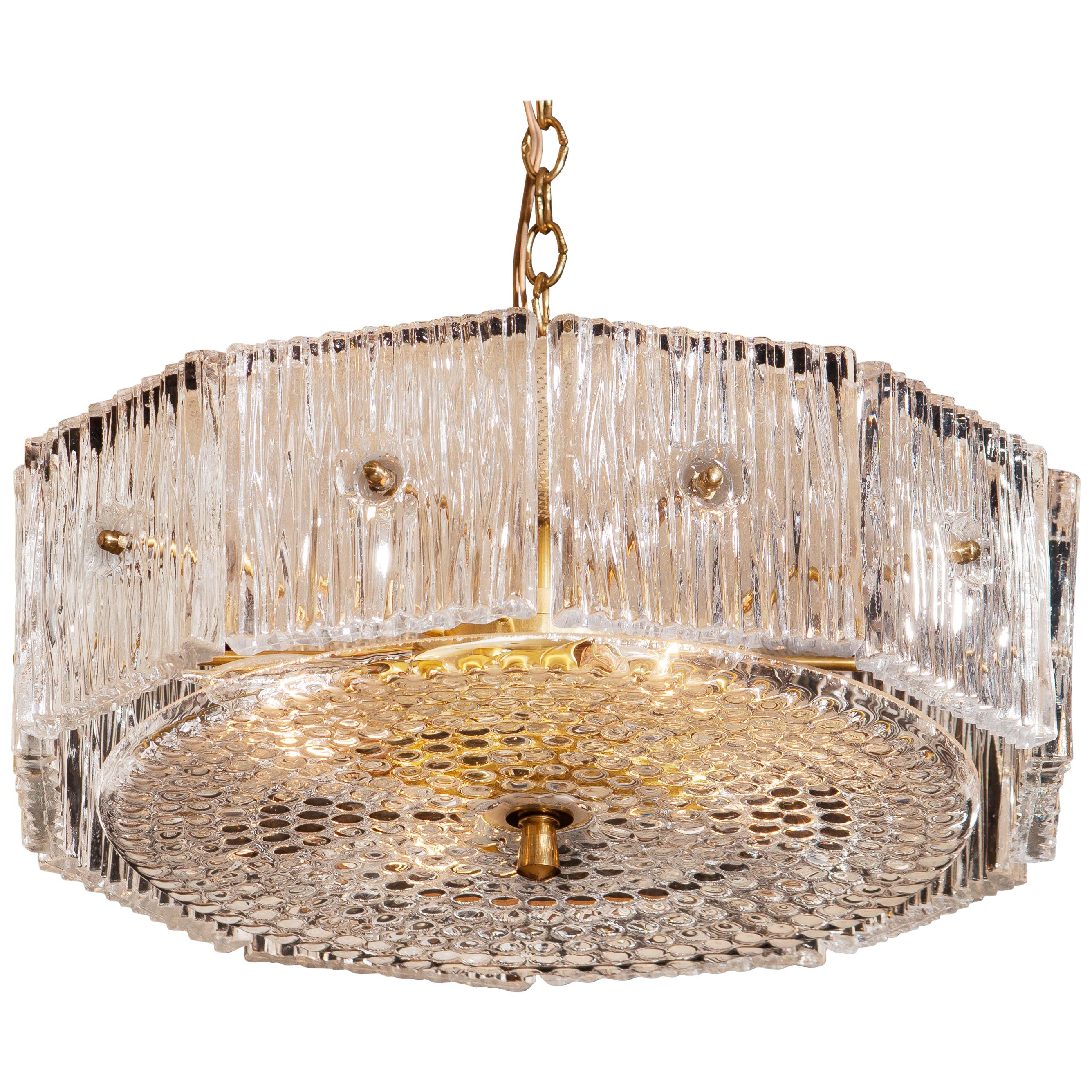 Brass and clear crystal chandelier or pendant designed by Carl Fagerlund for Orrefors, Sweden.
This chandelier or pendant is in excellent condition and technically 100%.
Wired for 220 / 110 volt.
Period: 1960.
The dimensions of the crystal parts