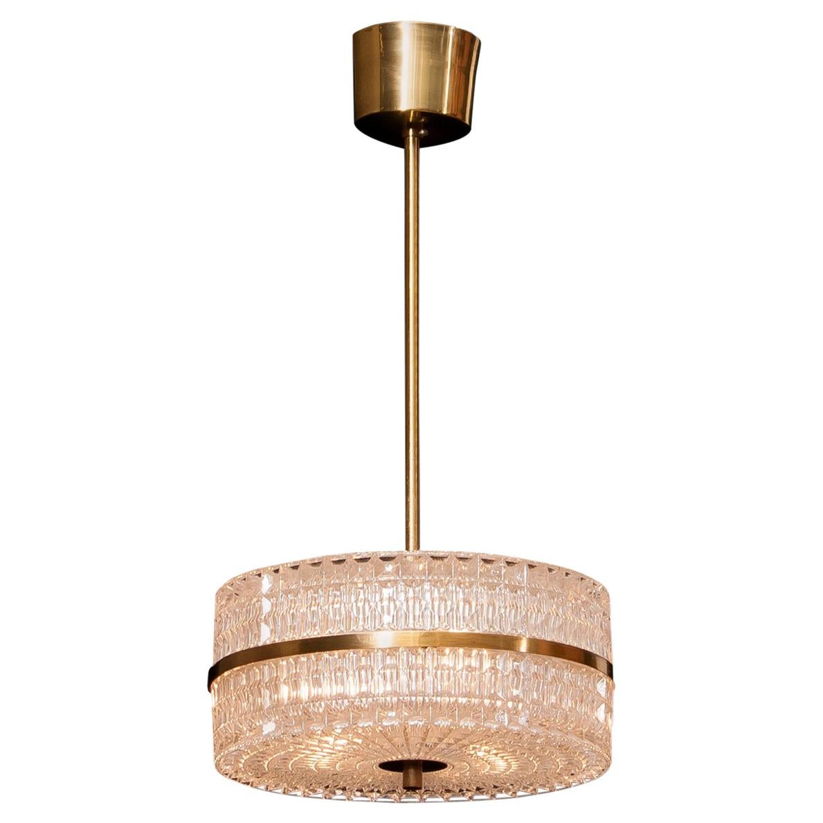 Beautiful ceiling lamp designed by Carl Fagerlund for Orrefors, Sweden.
The crystal glass with the brass details makes it a very nice combination.
It is in a wonderful working condition.
Period 1960s.
Dimensions: H 50 cm, ø 26 cm.