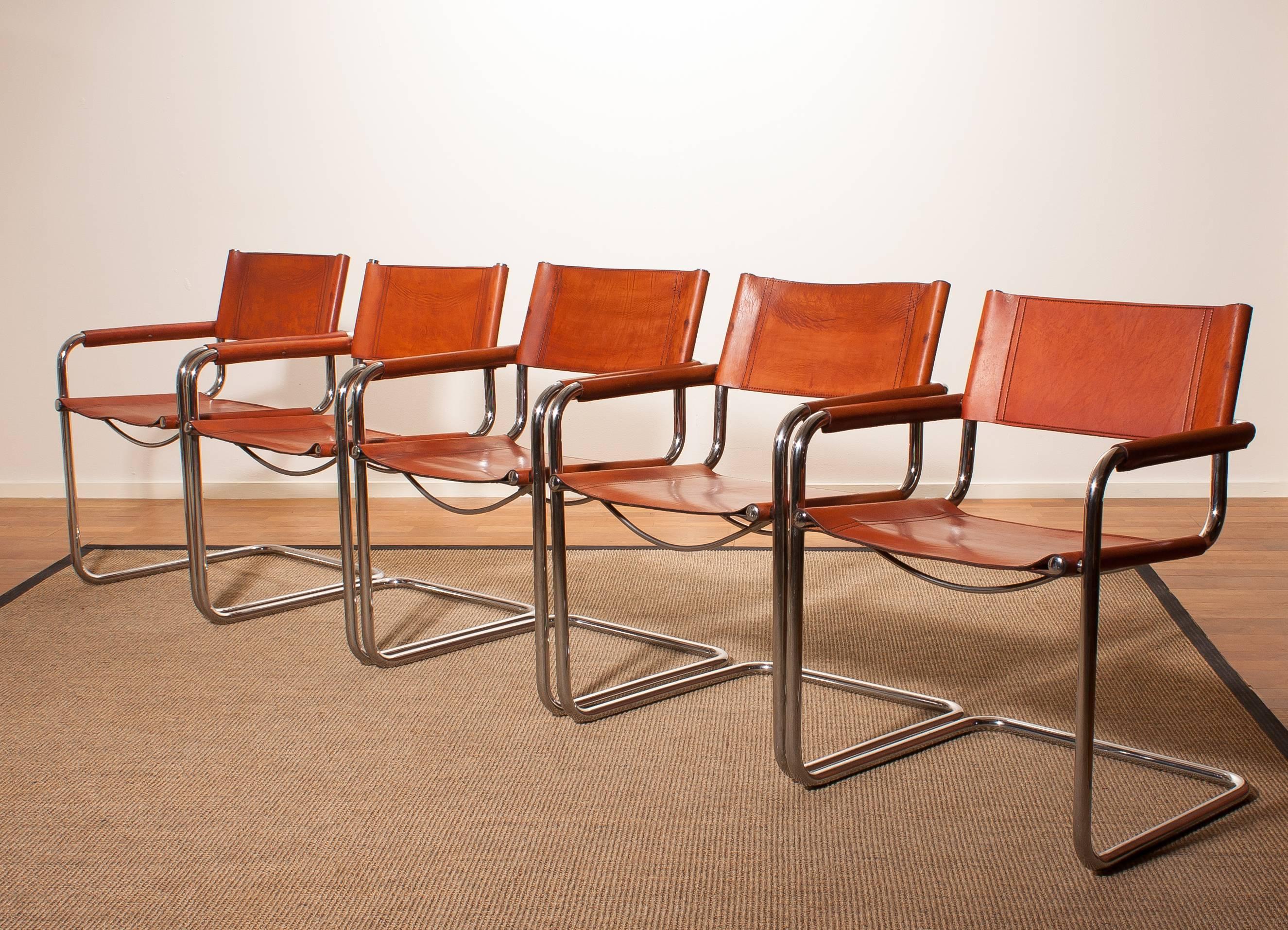 A set of five fine Italian dining chairs designed by Mart Stam for Jox Interni, Italy.
The chairs have a tubular chrome steel frame and the seat as well as the backrest and armrests are made of sturdy cognac leather.
The condition is in a nice