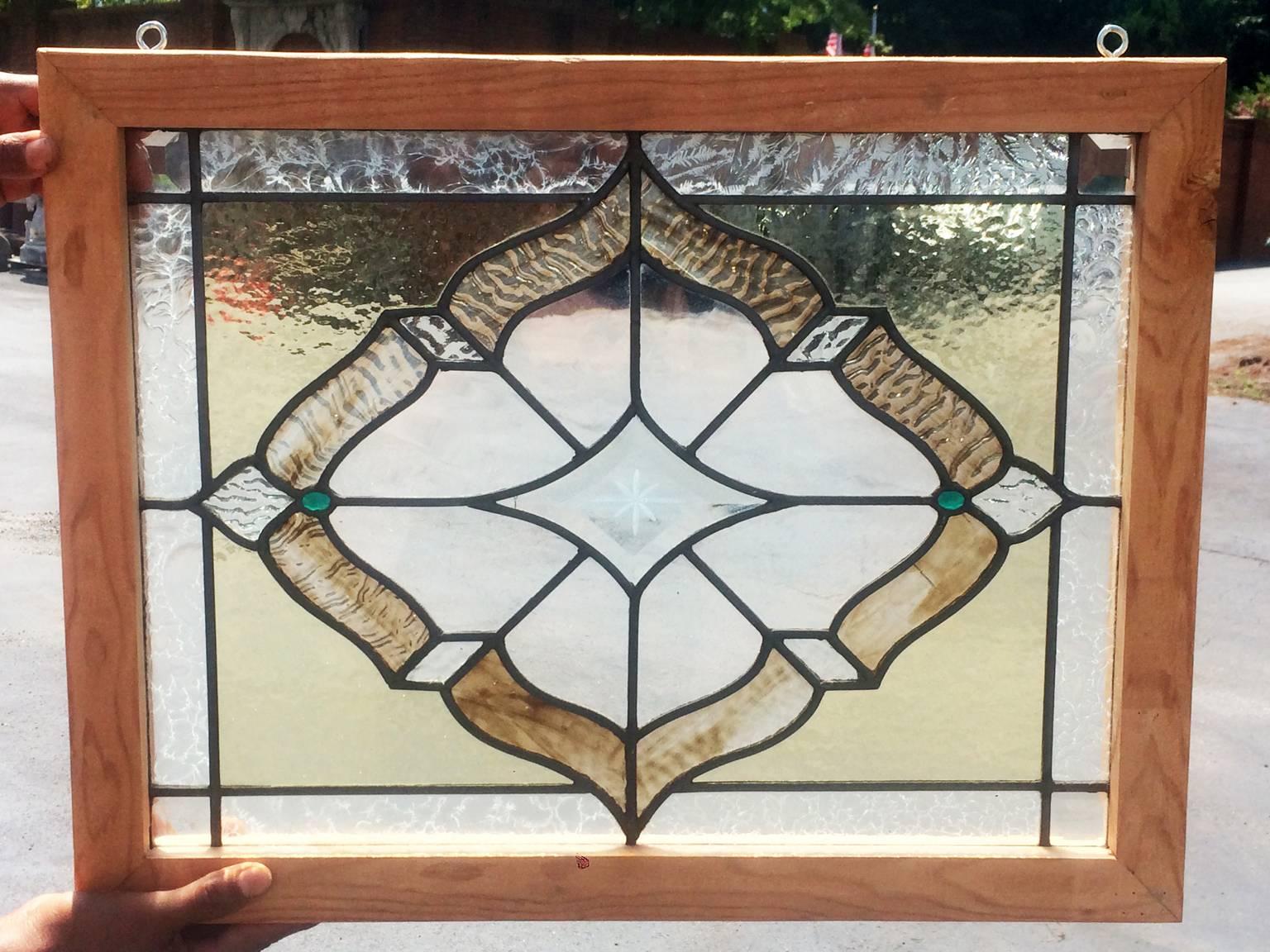 American Victorian stained, rippled, beveled, crackled, etched and jeweled window. This window is a wonderful piece with many glass different glass treatments going on. There are a few small cracks and the frame is new, but it still looks amazing.
