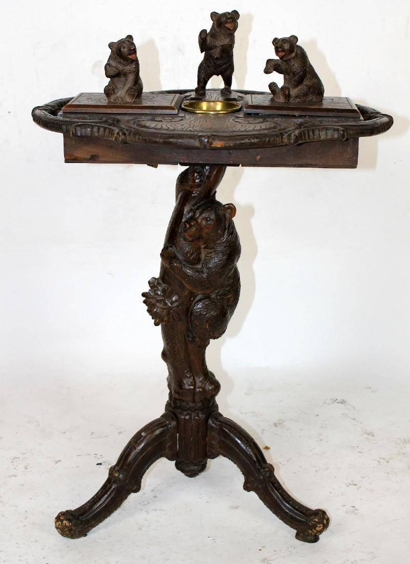 Very rare smoking stand with a naturalistic tree trunk base supporting a plateau. There is a bear climbing on the trunk and there are three frolicking bears on the plateau. The bear on the right of the plateau is seated over a compartment for