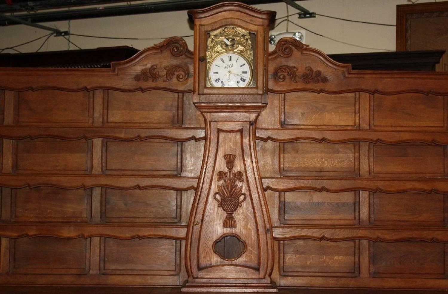 This magnificent piece is perfect for a country kitchen. It is a monumental carved oak buffet or vaisselier which was designed as a focal point for the room. It features a large central clock and open shelves to hold plates, glassware, and serving