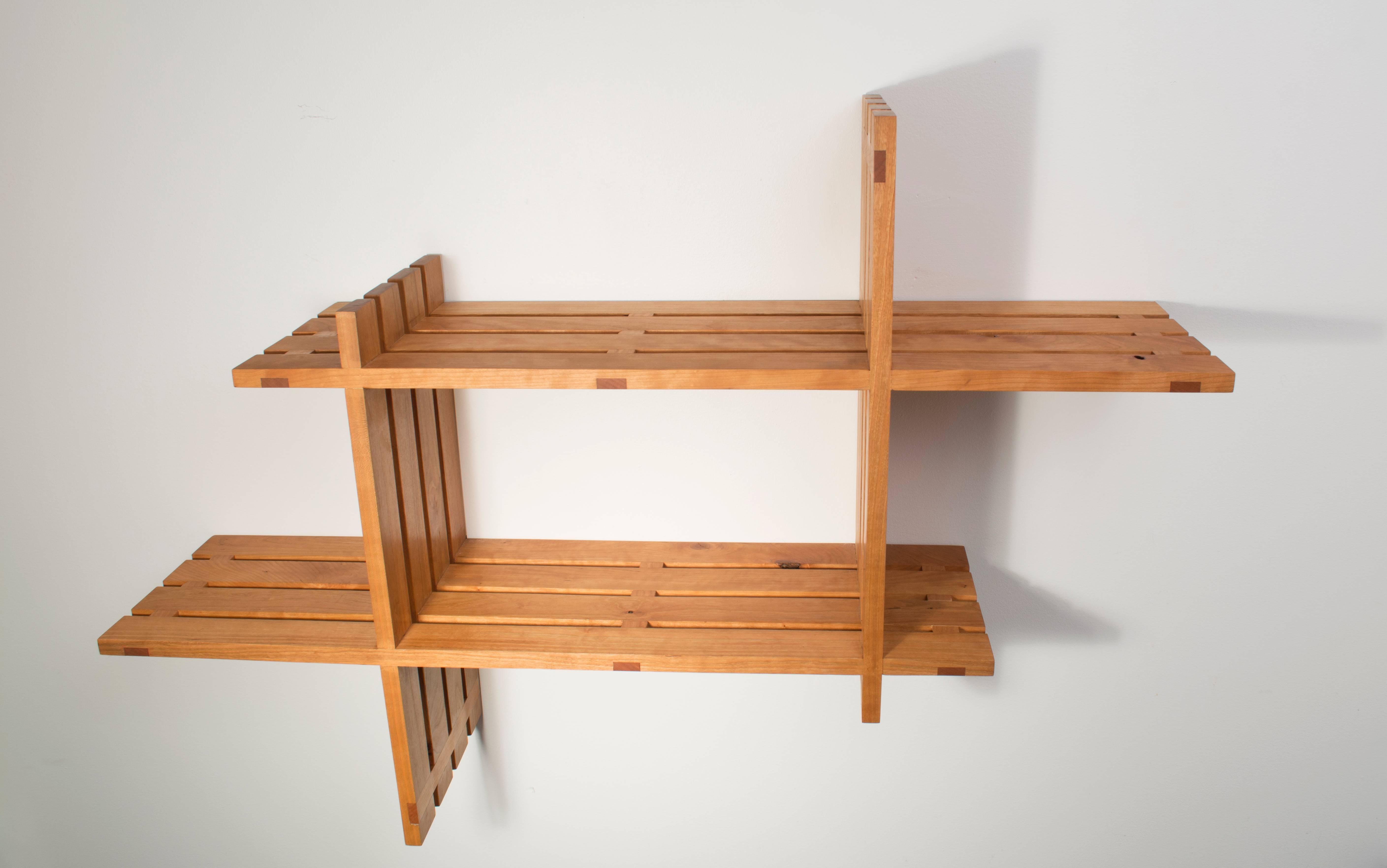 Measurements of pictured version: 42 x 11 x 28 inches (L x D x H).
These solid cherry shelves are made by hand with traditional wood joinery.
The version pictured has 48 wood joints, adding complexity and strength to the piece. All wood is