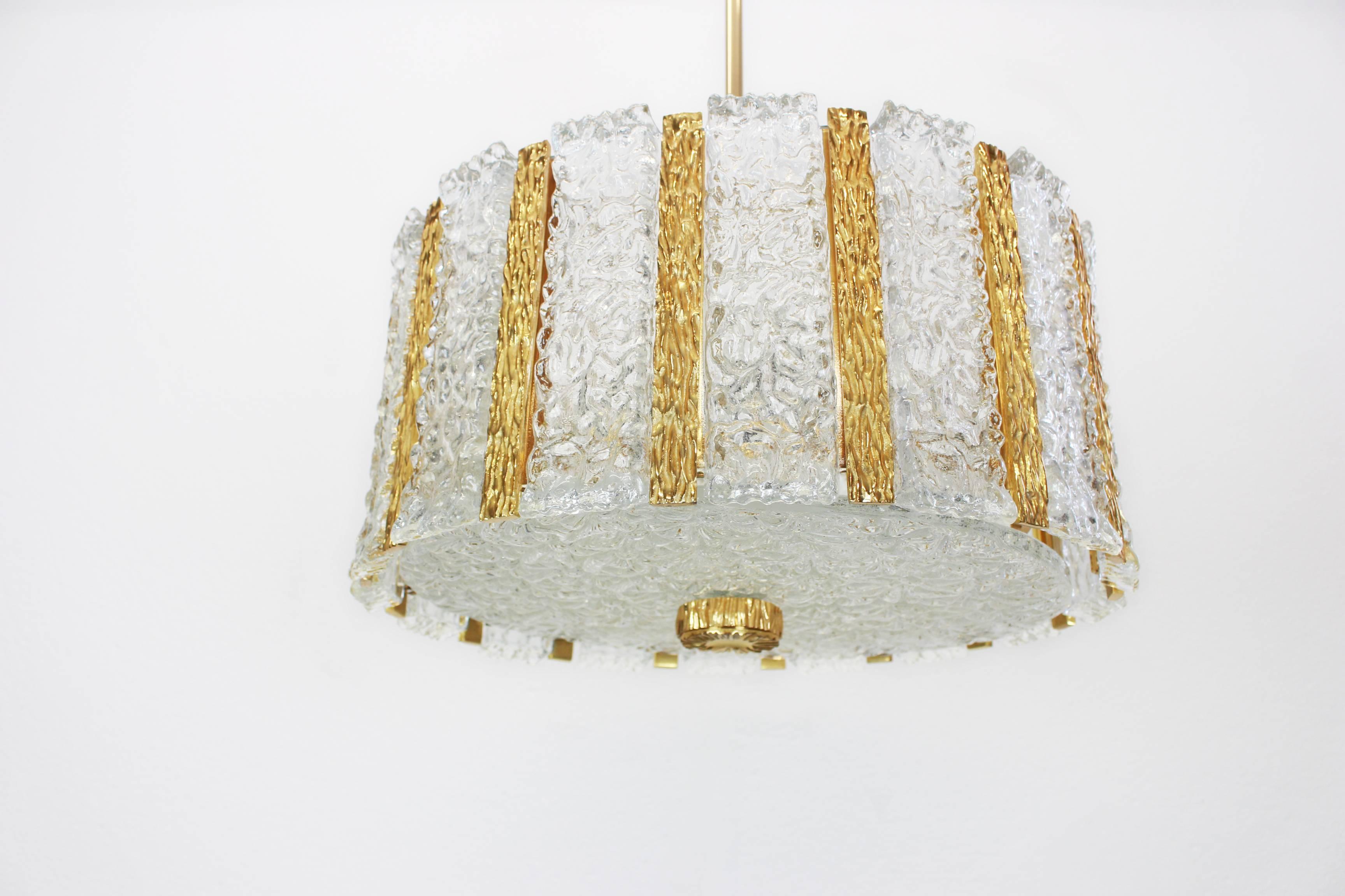 Gold-plated drum-shaped chandelier with 16 frosted glass panels on a gilt brass frame with a Brutalist inspired pattern. Best of design from the 1960s by J.T. Kalmar, Austria. 

High quality and in very good condition. Cleaned, well-wired and ready