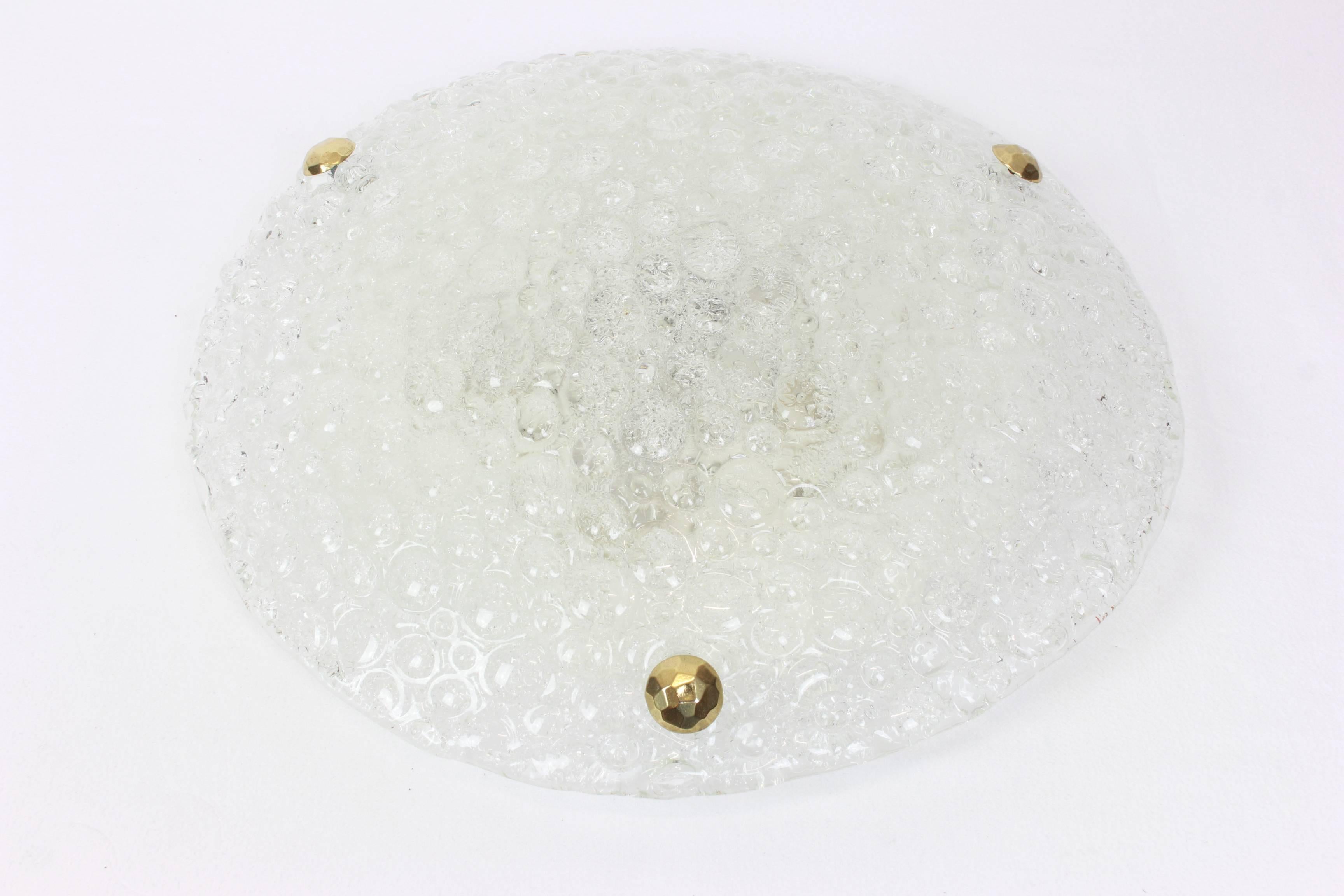 A Wonderful round ice glass flush mount by Hillebrand Leuchten, Germany, 1970s.
Thick textured Murano ice glass fixtured on a white metal base with three brass screws.

High quality and in very good condition. Cleaned, well-wired and ready to use.