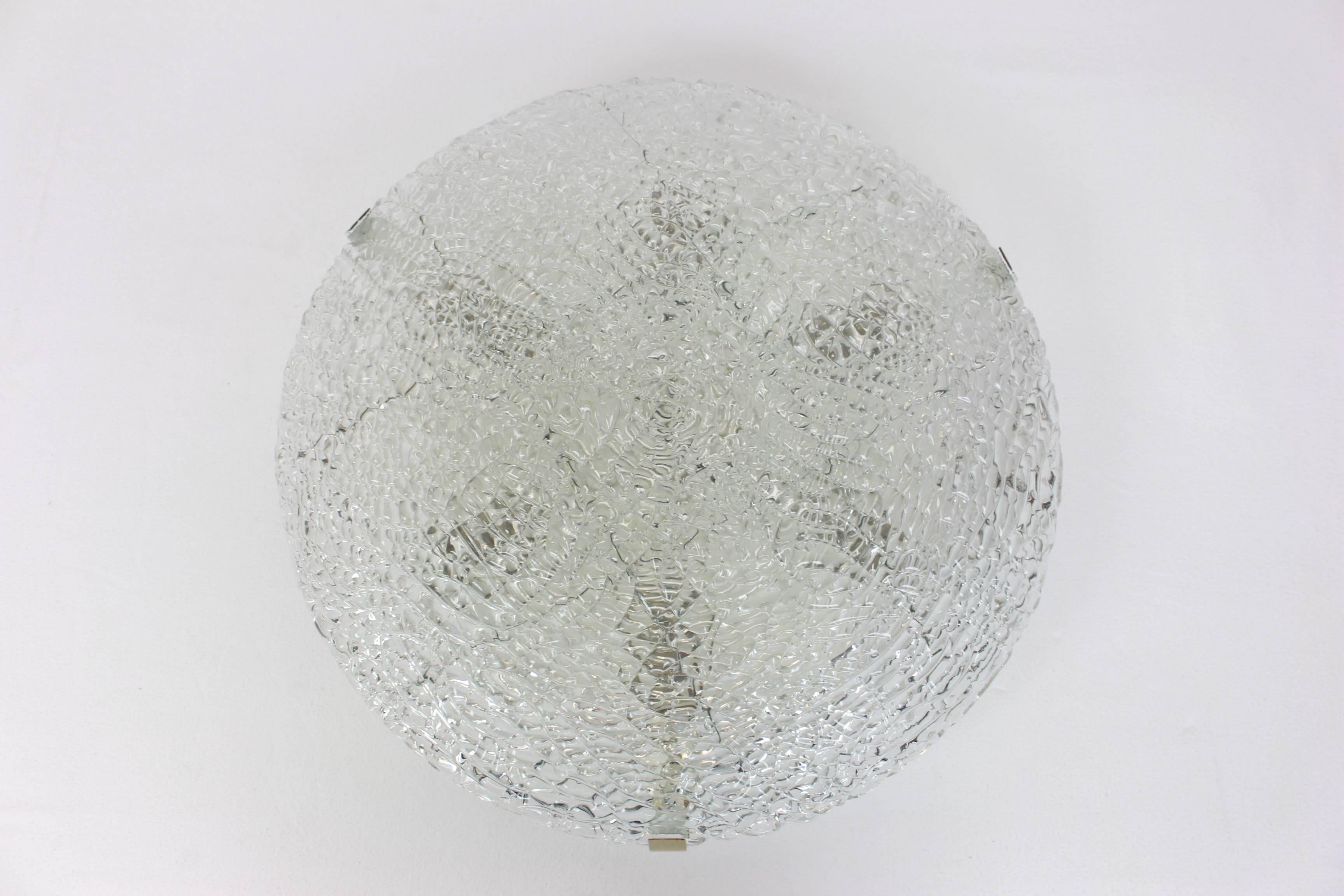 A wonderful round ice glass flush mount, by Kalmar, Austria, 1960s.
Thickly textured Ice glass fixture on a white metal base.


 High quality and in perfect condition. Cleaned, well-wired and ready to use. 

The fixture requires 6 x E14 Standard