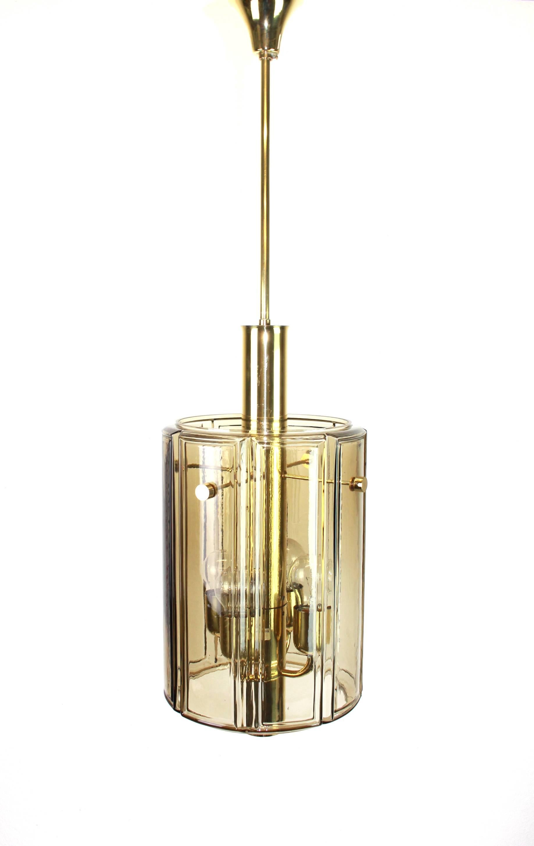 Brass lantern form pendant with smoked glass panels by Limburg, Germany, 1960s
Sockets: Four x E27 standard bulbs.
 
Very good condition.
Small signs of age and use.
Six pieces available.
Drop rod can be adjusted as required, free of charge,