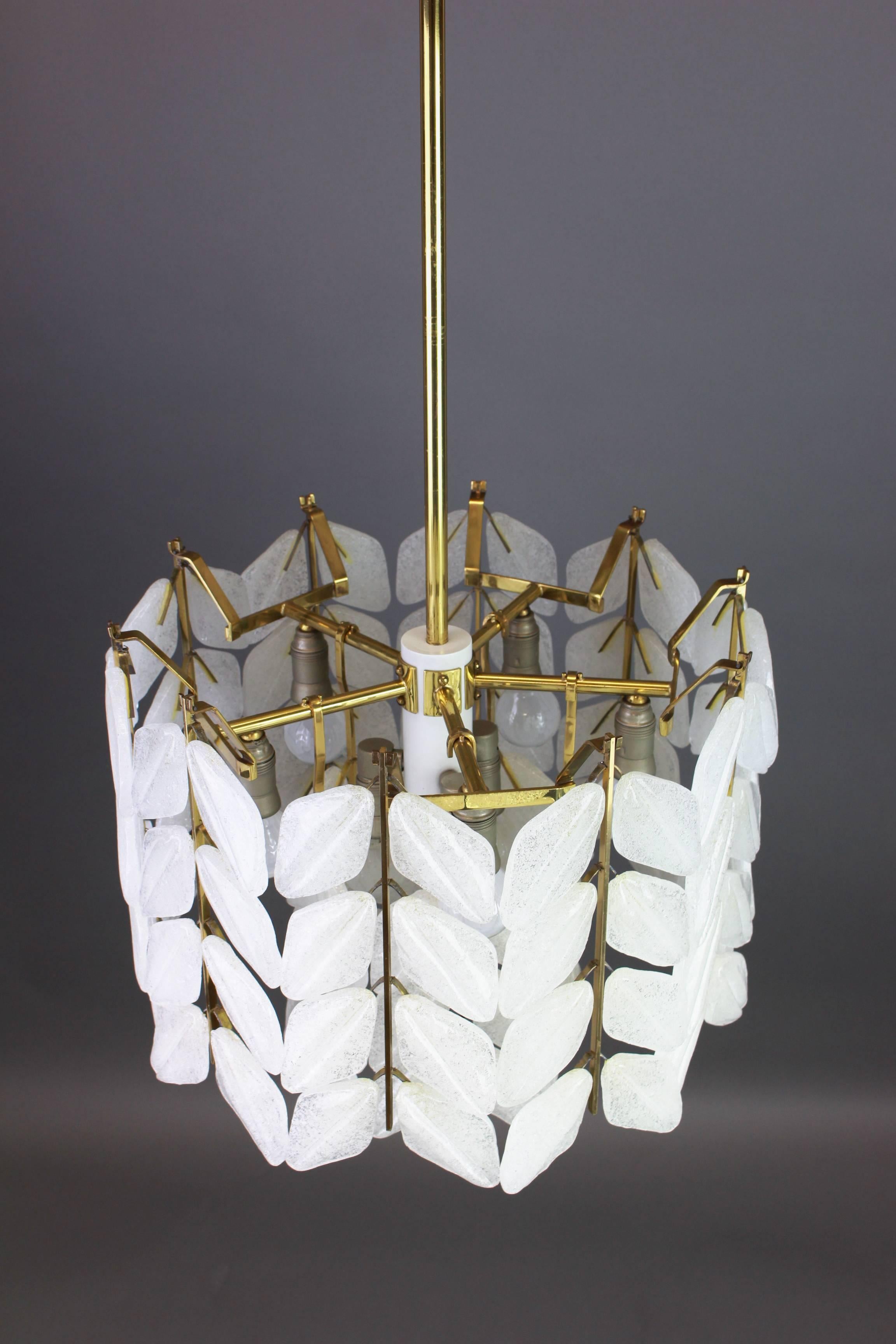 A stunning chandelier by Kalmar, Austria, manufactured in circa 1960-1969. A handmade and high quality piece. The ceiling fixture and the frame are made of brass with lots of Murano glass elements in the form of leaves.

Sockets: 8 x E14 small