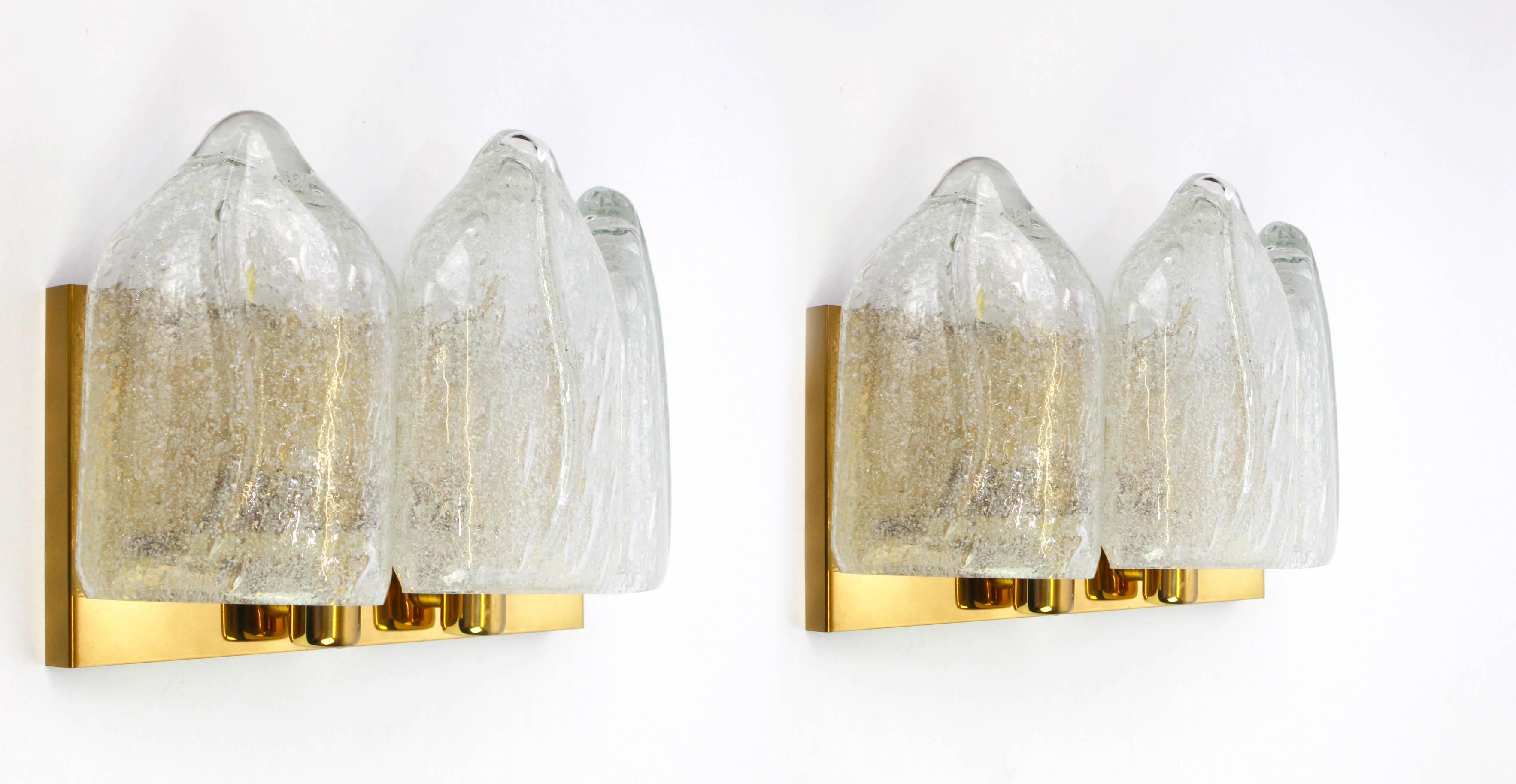 Wonderful pair of Mid-Century wall sconces with ice glass tubes, made by Doria Leuchten, Germany, manufactured, circa 1960-1969.

Each wall sconce needs two small Edison balls ( E-14) up to 40 watts each and function on voltage from 110 till 240