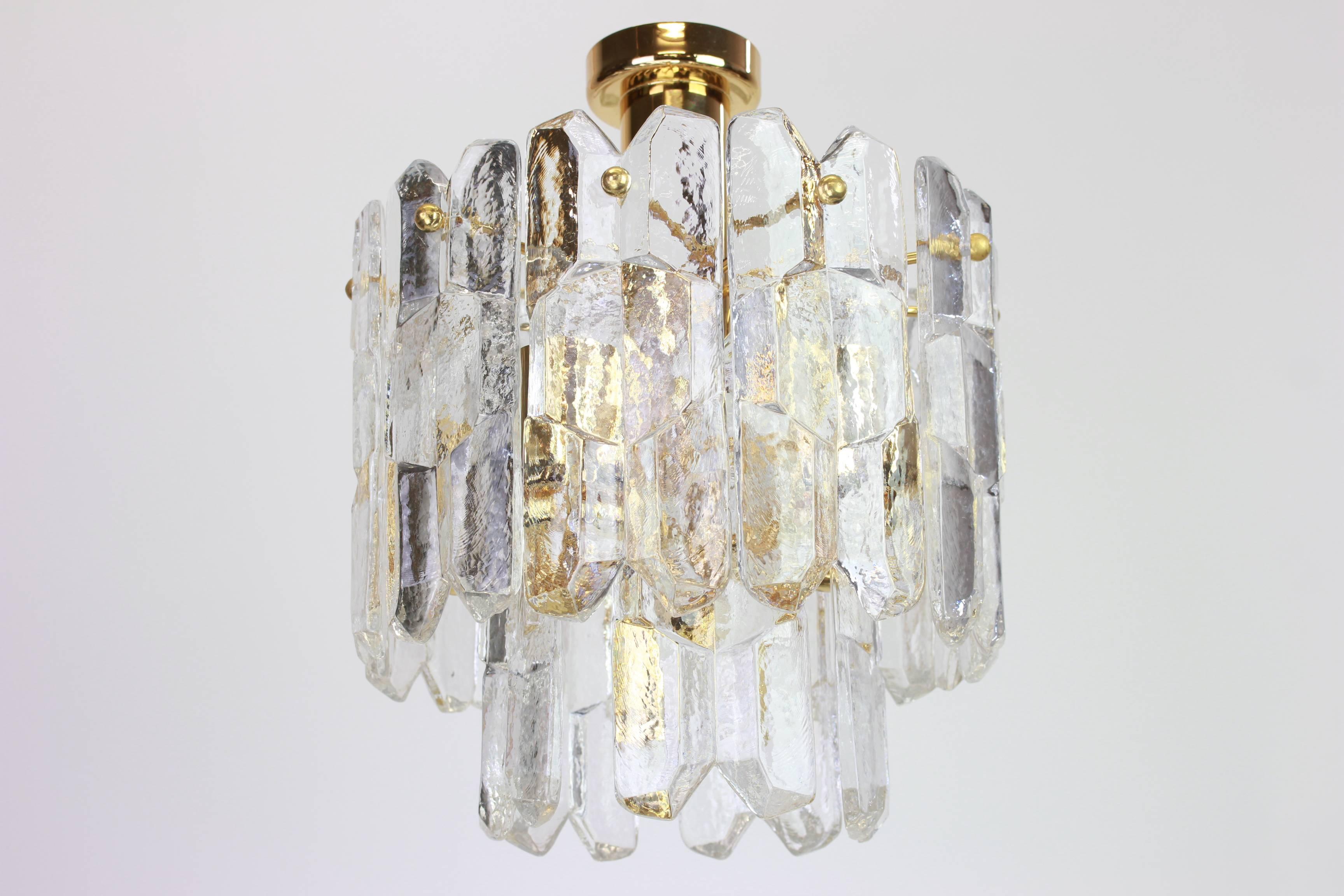 Wonderful gilt brass light fixture comprises 15 crystal Murano glass pieces on gilded brass frame. Its made by Kalmar (Serie: Palazzo), Austria, manufactured, circa 1970-1979.

Two tiers structure gathering many structured glasses, beautifully
