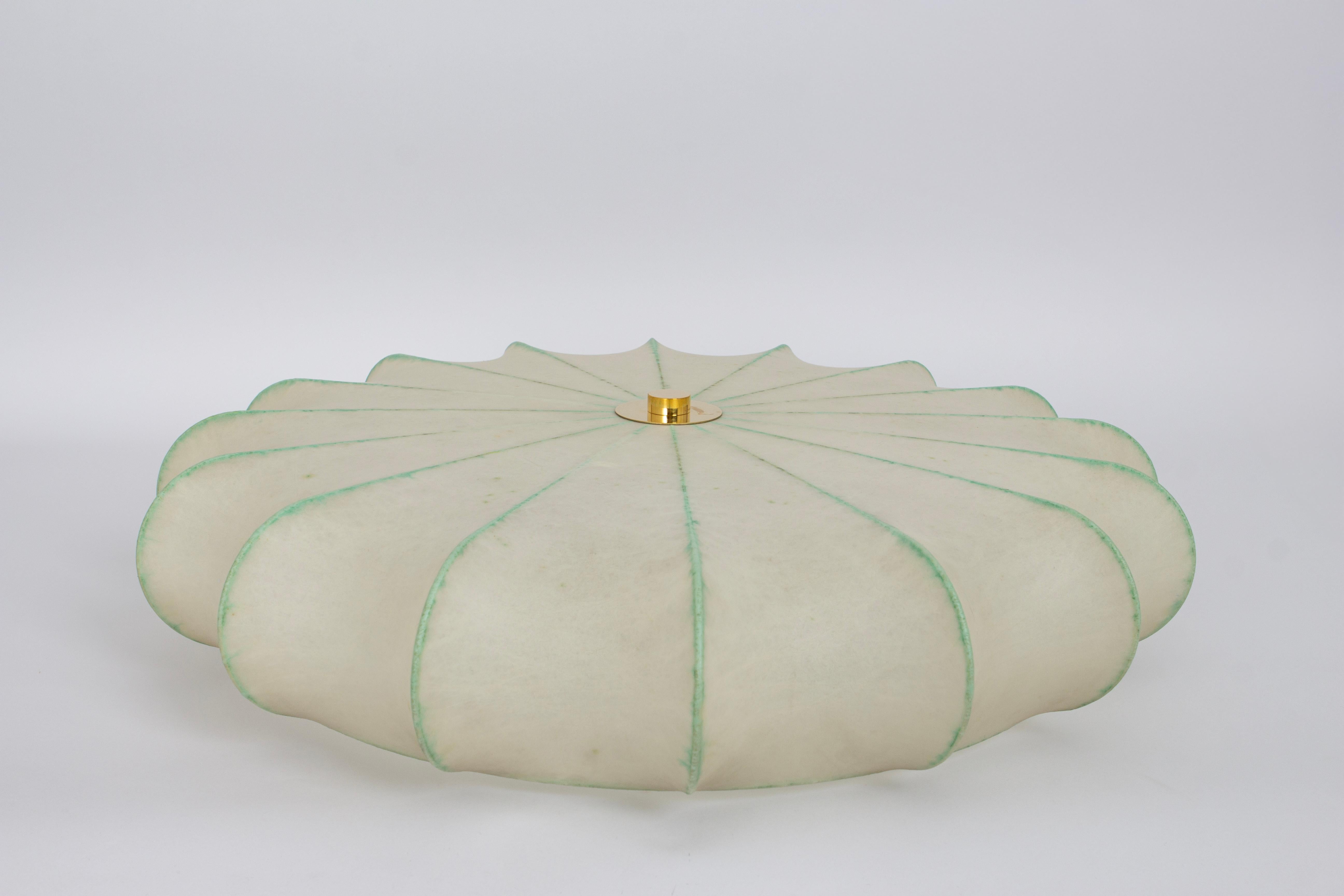 This elegant Cocoon ceiling lamp was made in Germany in the 1970s. It has a simple, stylish shape that reminds one of the work of famous designer Achille Castiglioni. The round form flares out slightly, giving it a unique look that stands out in any