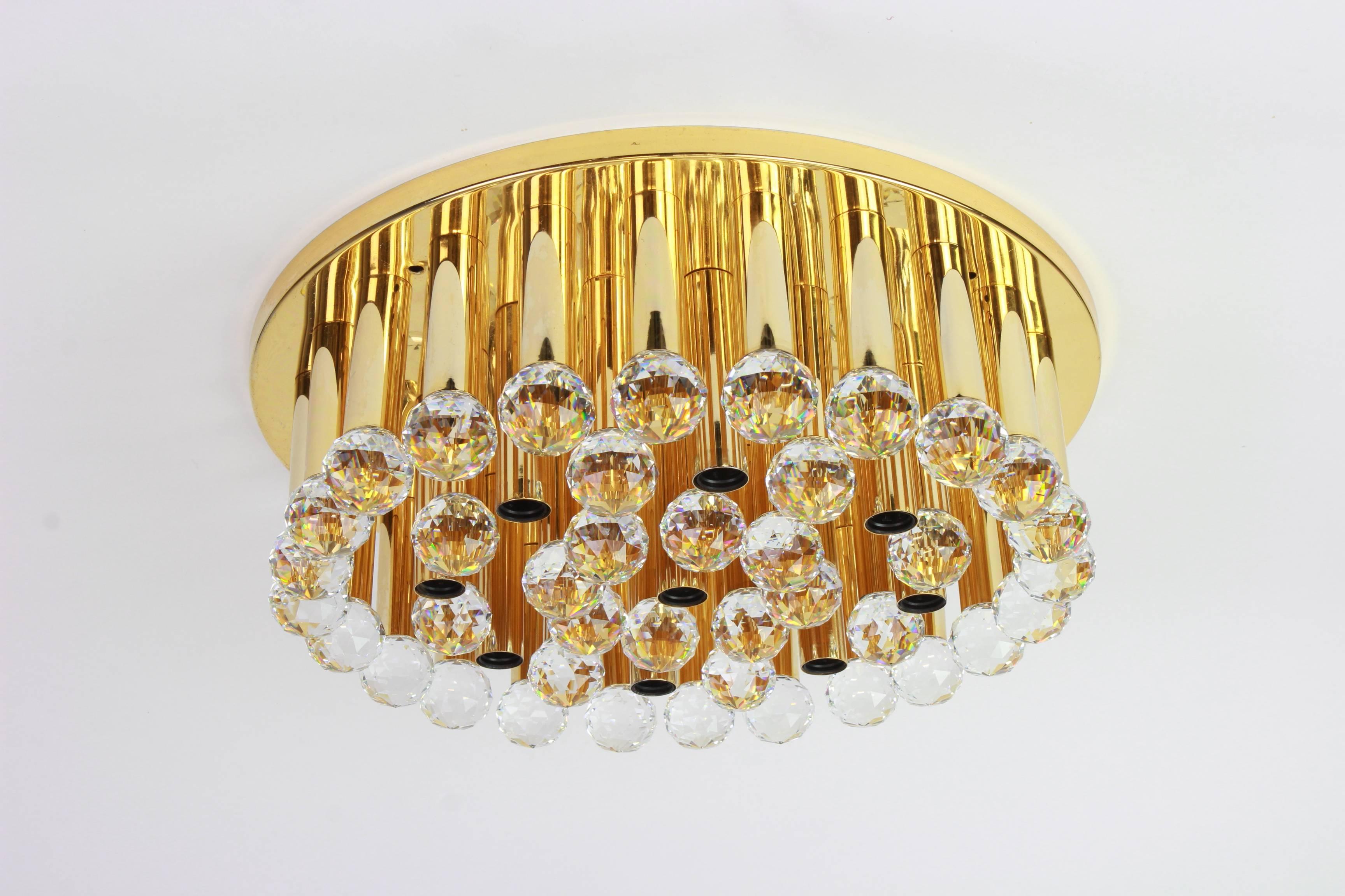 A stunning flush mount fixture by Christoph Palme, Germany, manufactured in 1970s. It’s composed of crystal drop glass pieces on a gilded brass frame.

High quality and in very good condition with some small scratches on the base (which are not seen