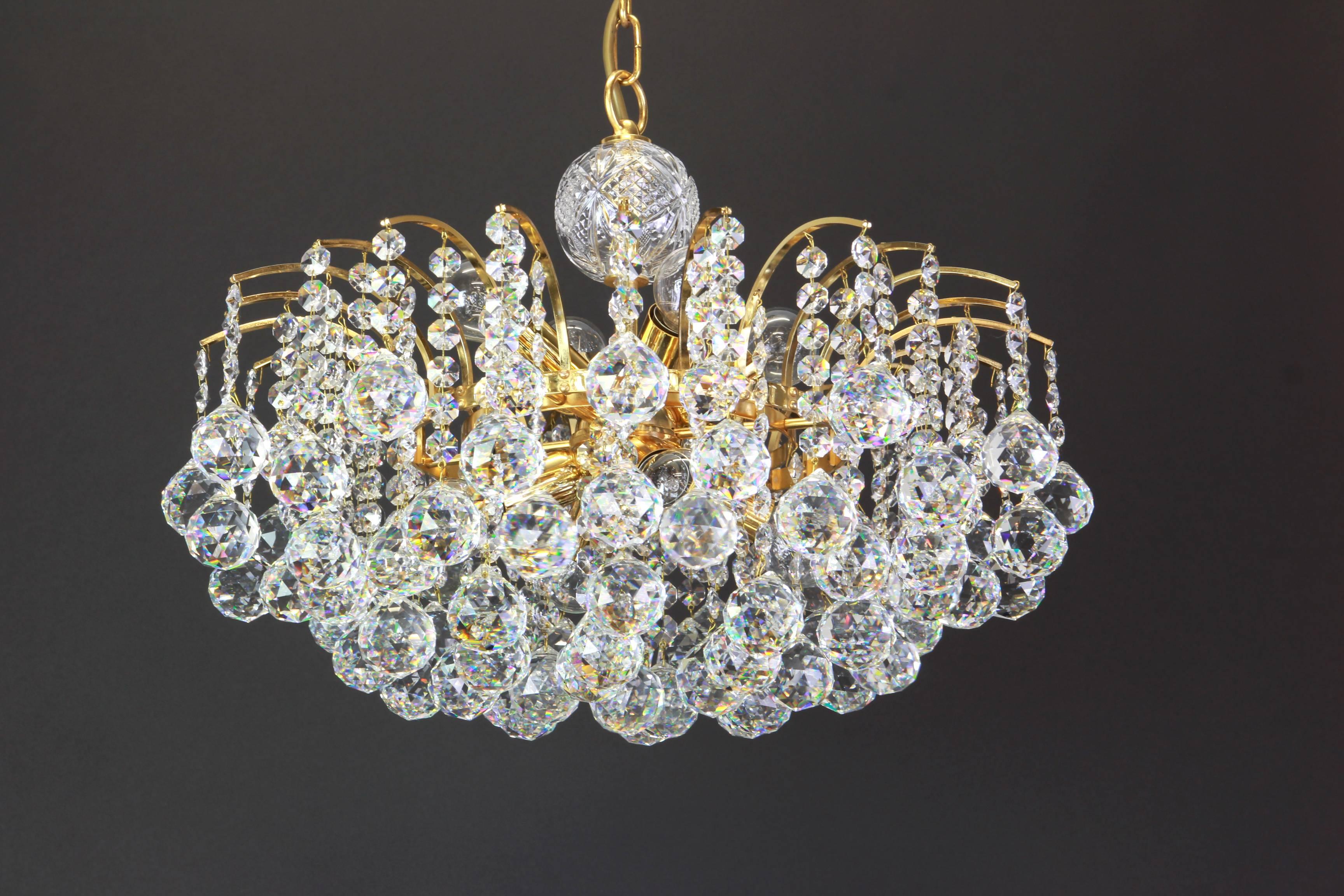 Elegant Chandelier with wonderful crystal balls on a brass base, suspended from tiny hooks.
From: Christoph Palme, Germany, circa 1970s. 

High quality and in very good condition. Cleaned, well-wired and ready to use. 

The fixture requires 8 x E14