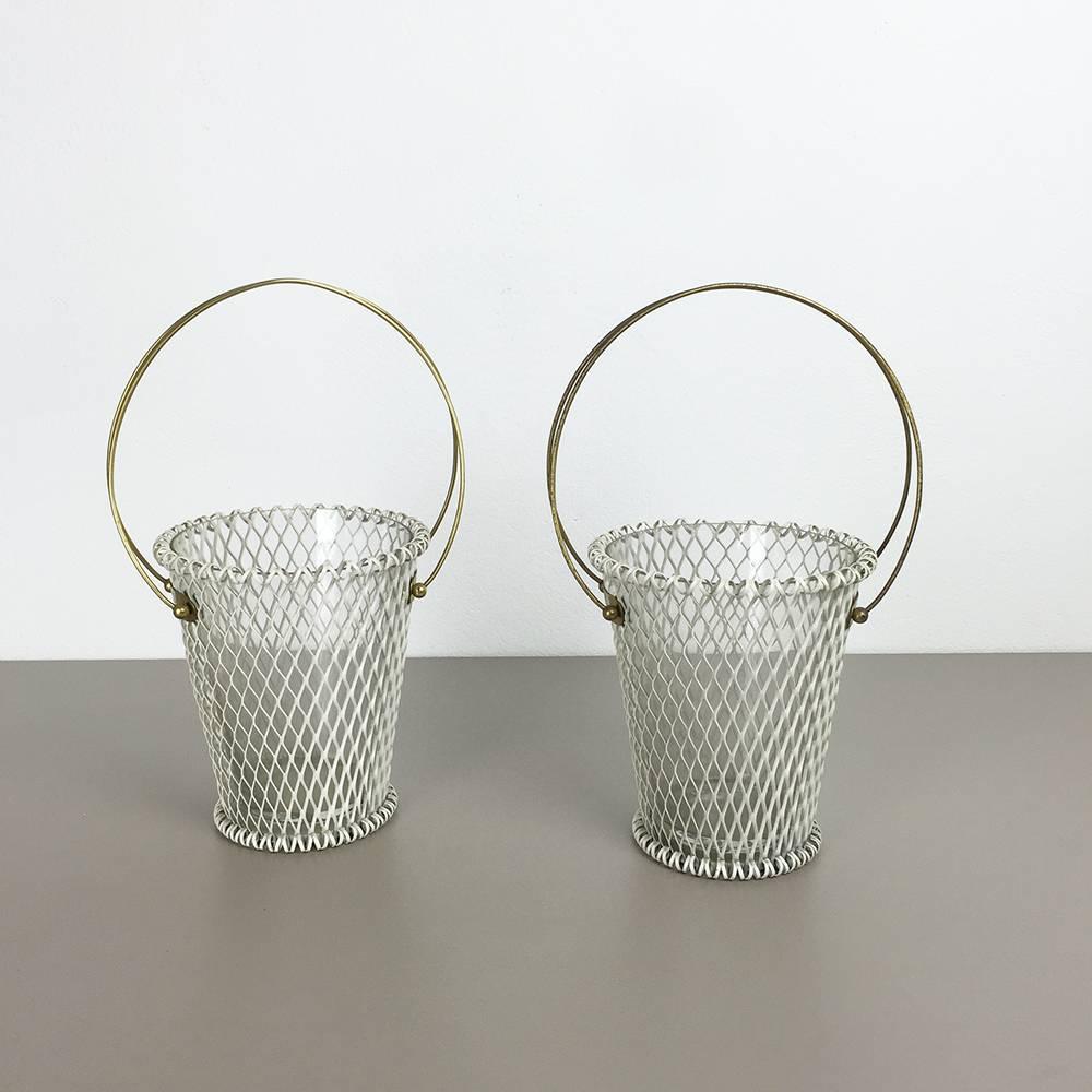 Article:

Set of two modernist metal plant pots vases.


Description:

This original set of two modernist plant pots vases was produced in the 1960s in France. It is made of white lacquered metal with a round brass handle at the top. Each pot