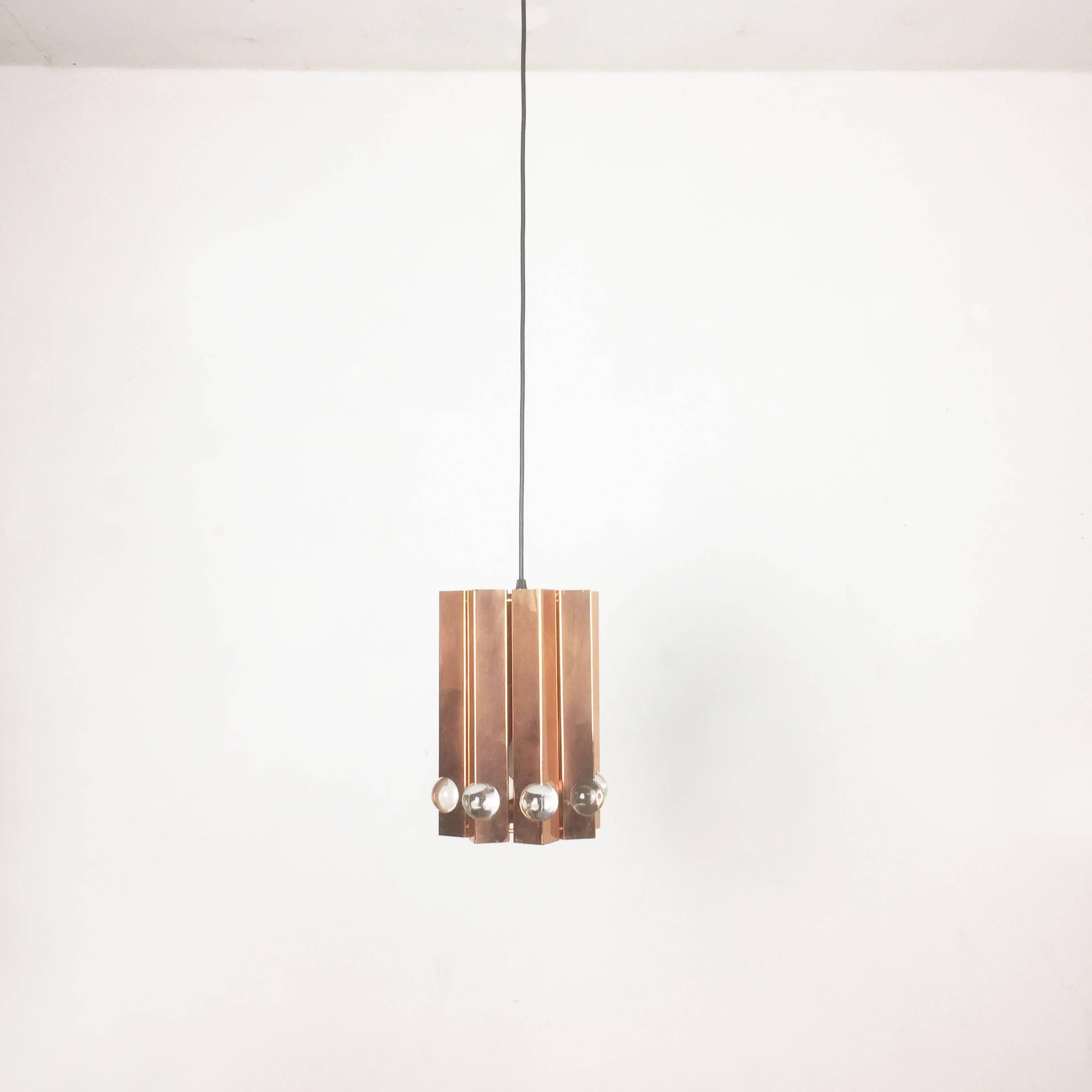 Article:

hanging light



Origin:

Denmark



Age:

1960s


Description:

This hanging lamp was designed and produced in the 1960s in Denmark. The piece is made from solid metals with copper tone finish, and has cubic perforation