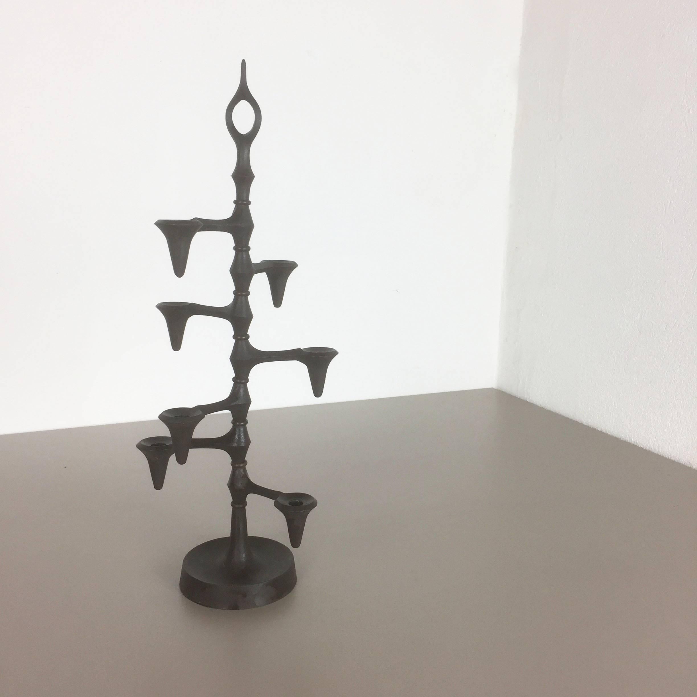 Candleholder. 

Producer: Dansk Designs. 

Designed by Jens Harald Quistgaard, 1960s.

Original Danish candleholder designed by Jens Harald Quistgaard and produced by Dansk Design in the 1960s in Denmark. It is made of cast iron and features