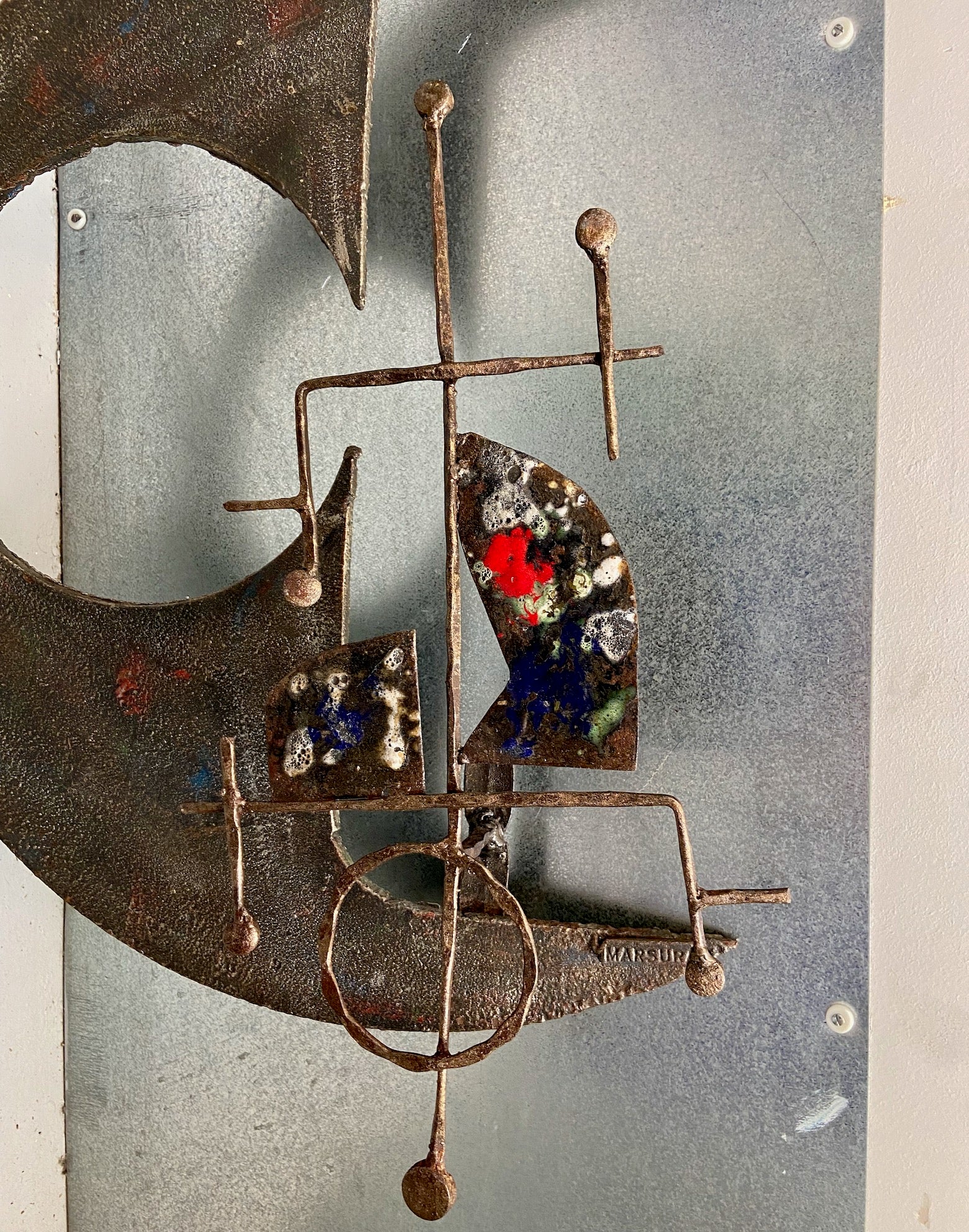 A large wrought iron and enamel brutalist wall sculpture by Salvino Marsura circa 1970's 
with red blue white and green enamel
there is a possibility that it could also be turned into a wall light / sconce.
signed front and back.