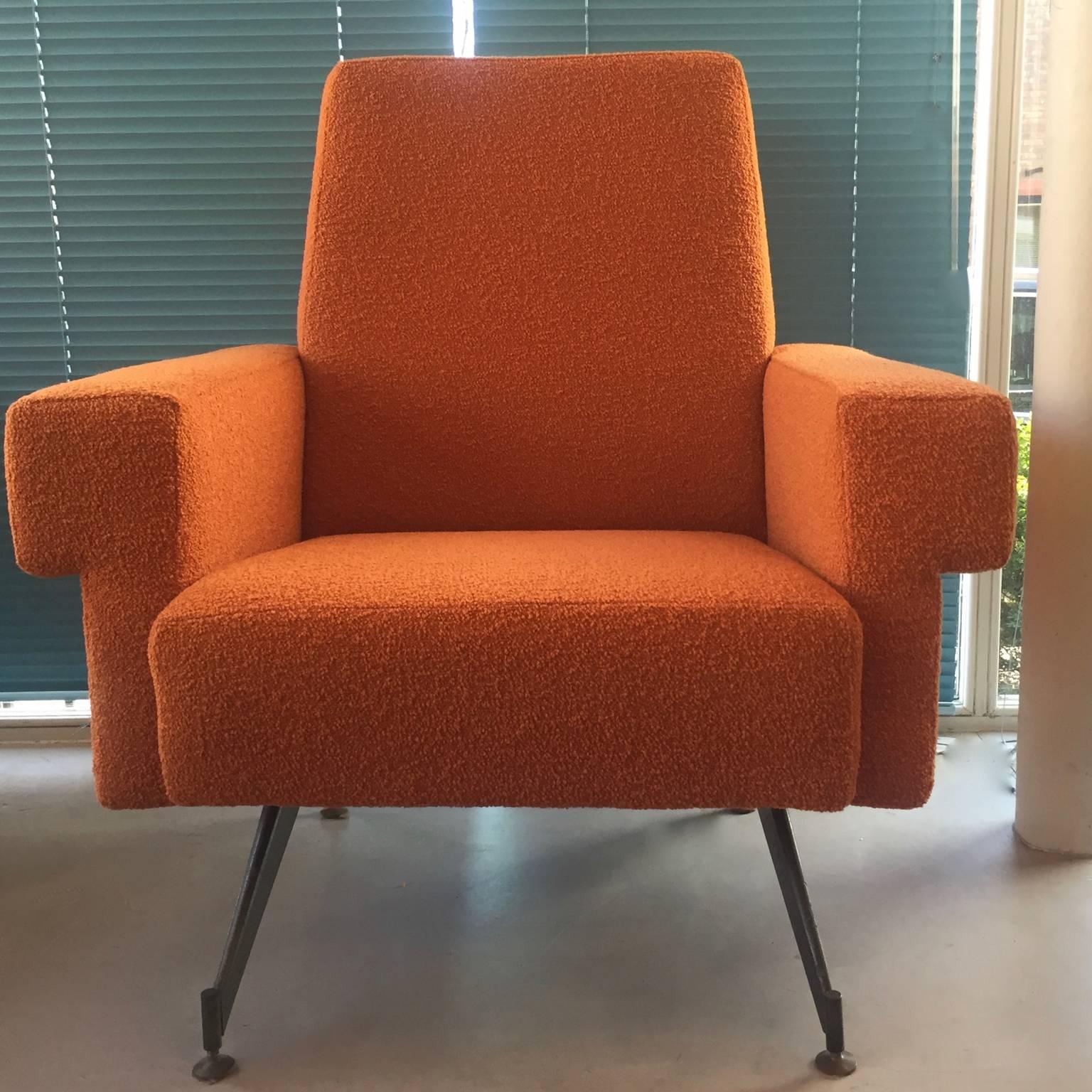 A pair of 1960s cubic armchairs reupholstered in an orange bouclé wool. Original Industrial grey base on adjustable feet, mid-century modern.