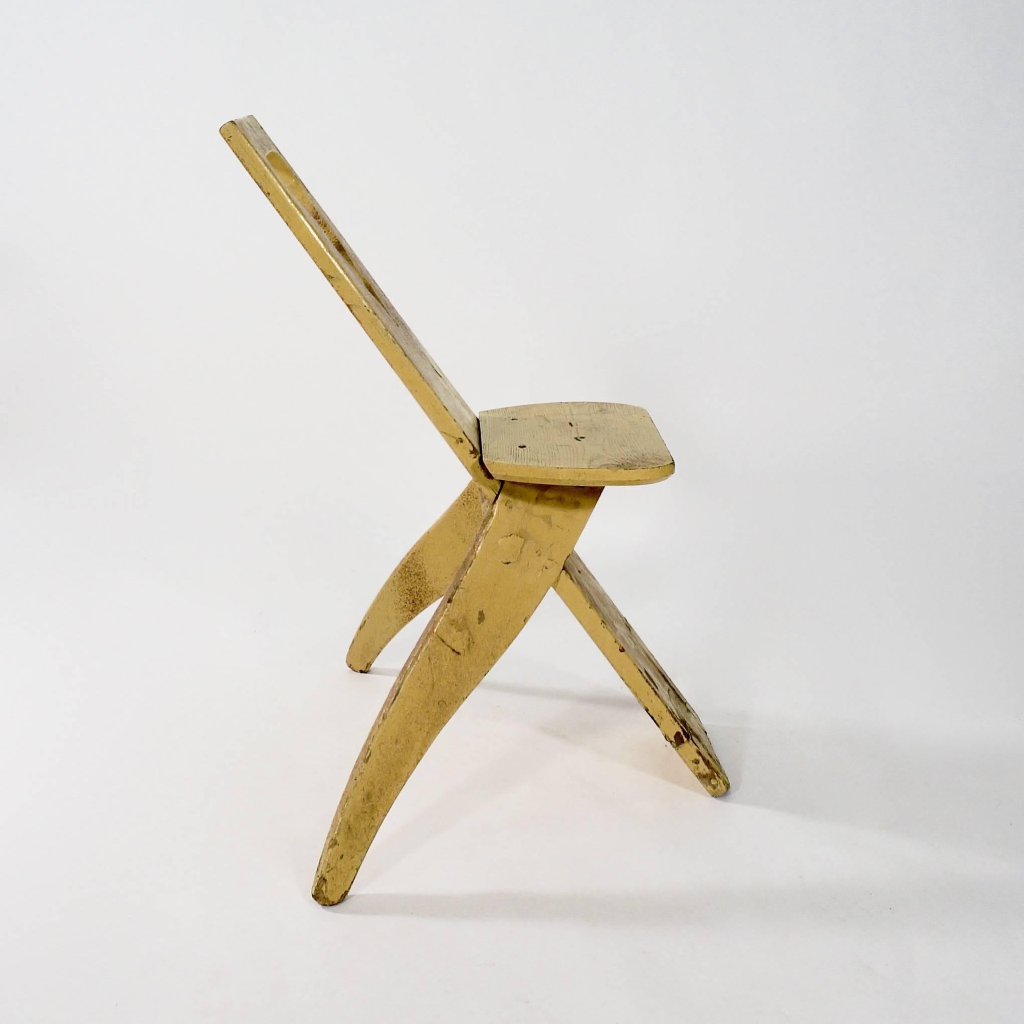 The plank back with a pierced motif with two shaped splaying back legs supporting a simple seat.

Sweden, circa 1900.