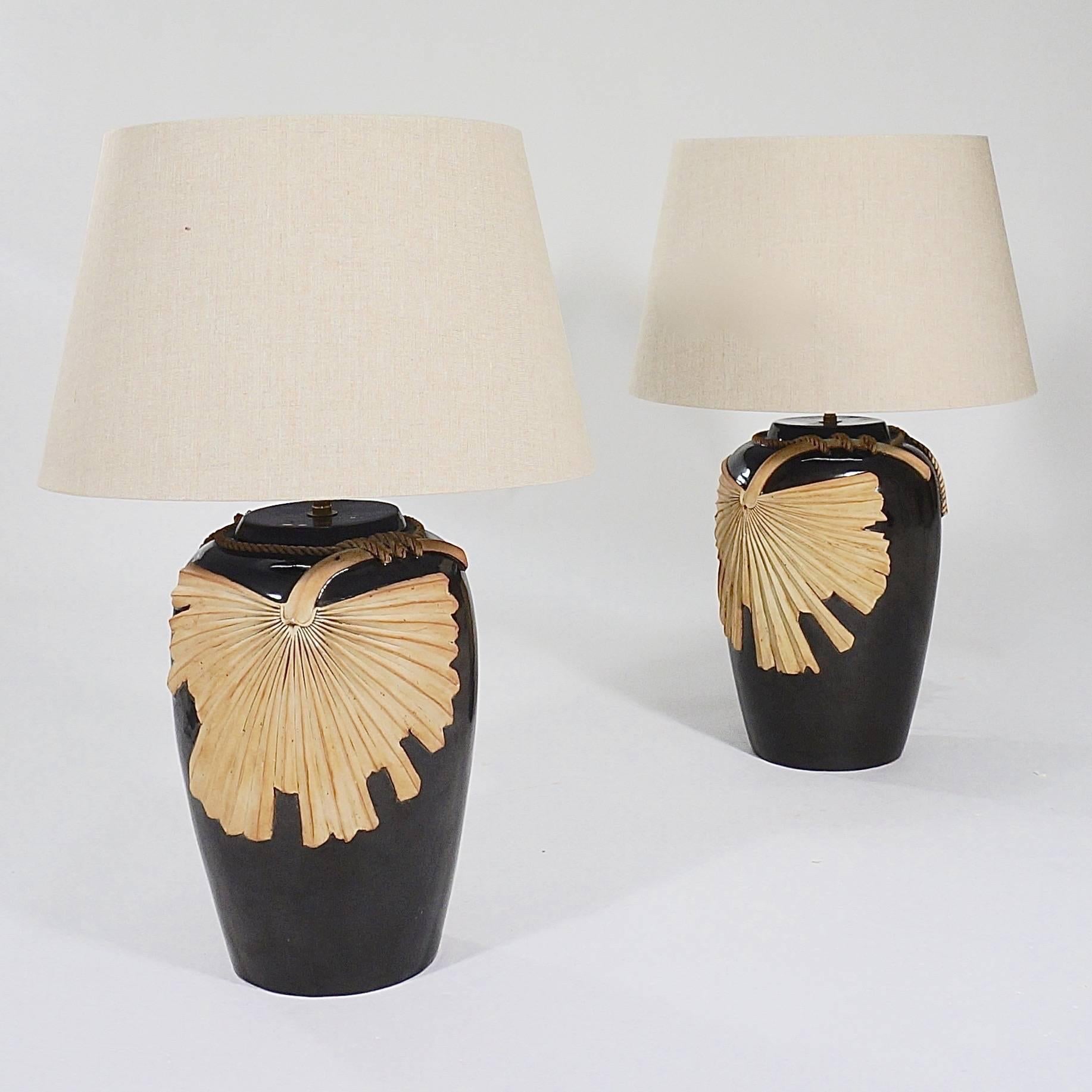 A pair of large Studio Pottery table lamps with a brown glaze and applied terracotta fan decoration

Probably, Italy, circa 1970s.