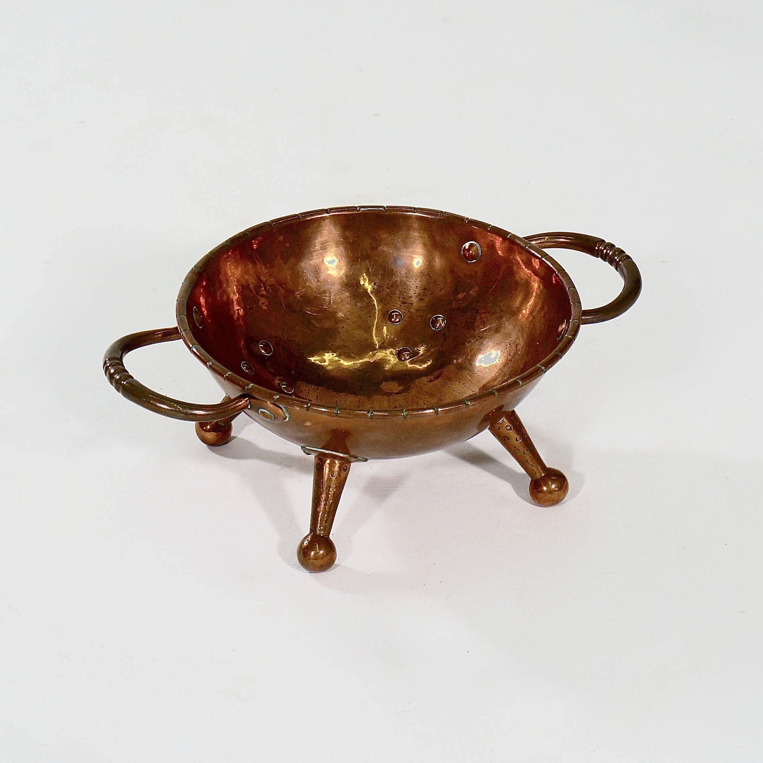 The bowl with a notched rim and supported by four rivetted drumstick feet.

England, circa 1860s.