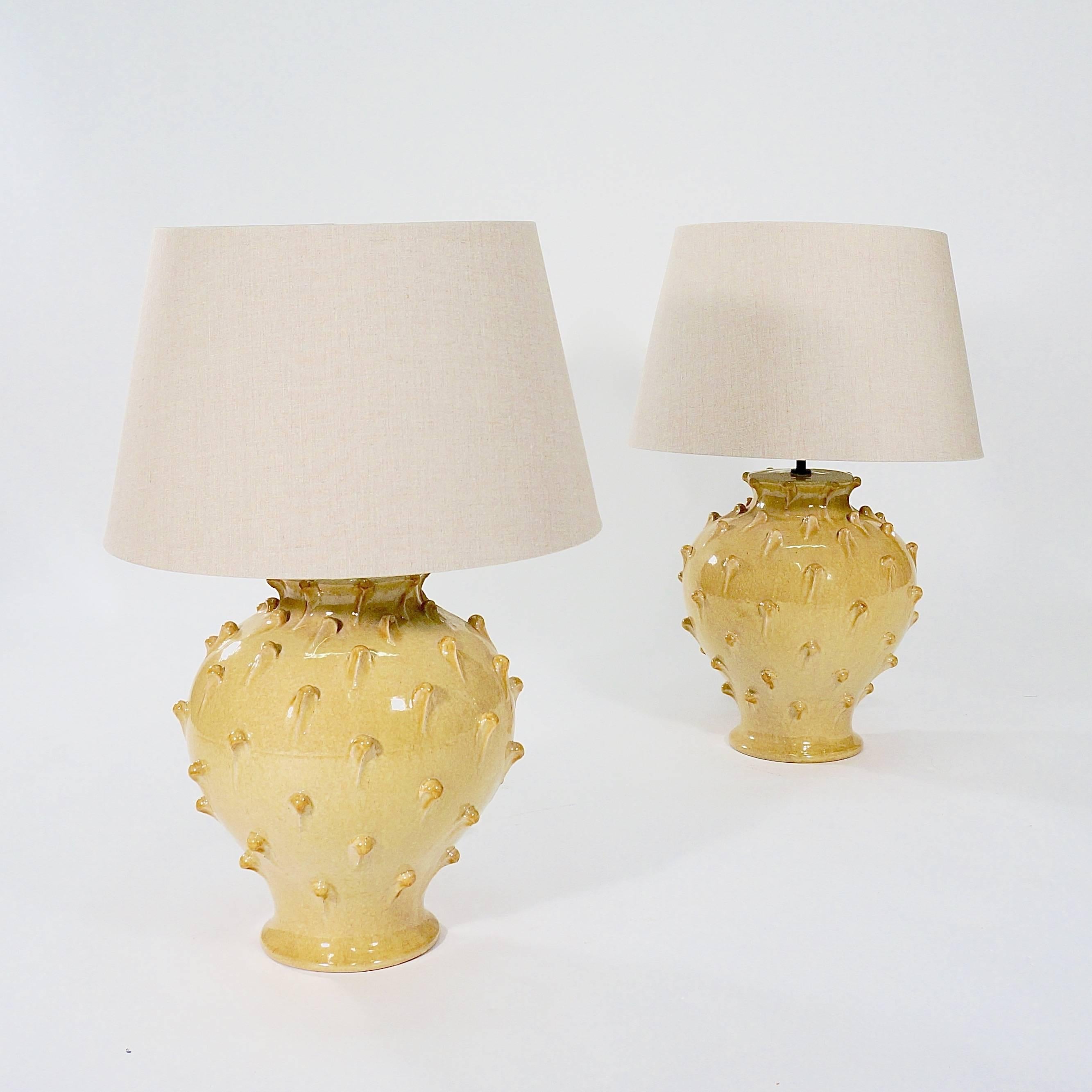 Each with pale ochre glaze and applied 'pulls,'

Italy, circa 1970s.