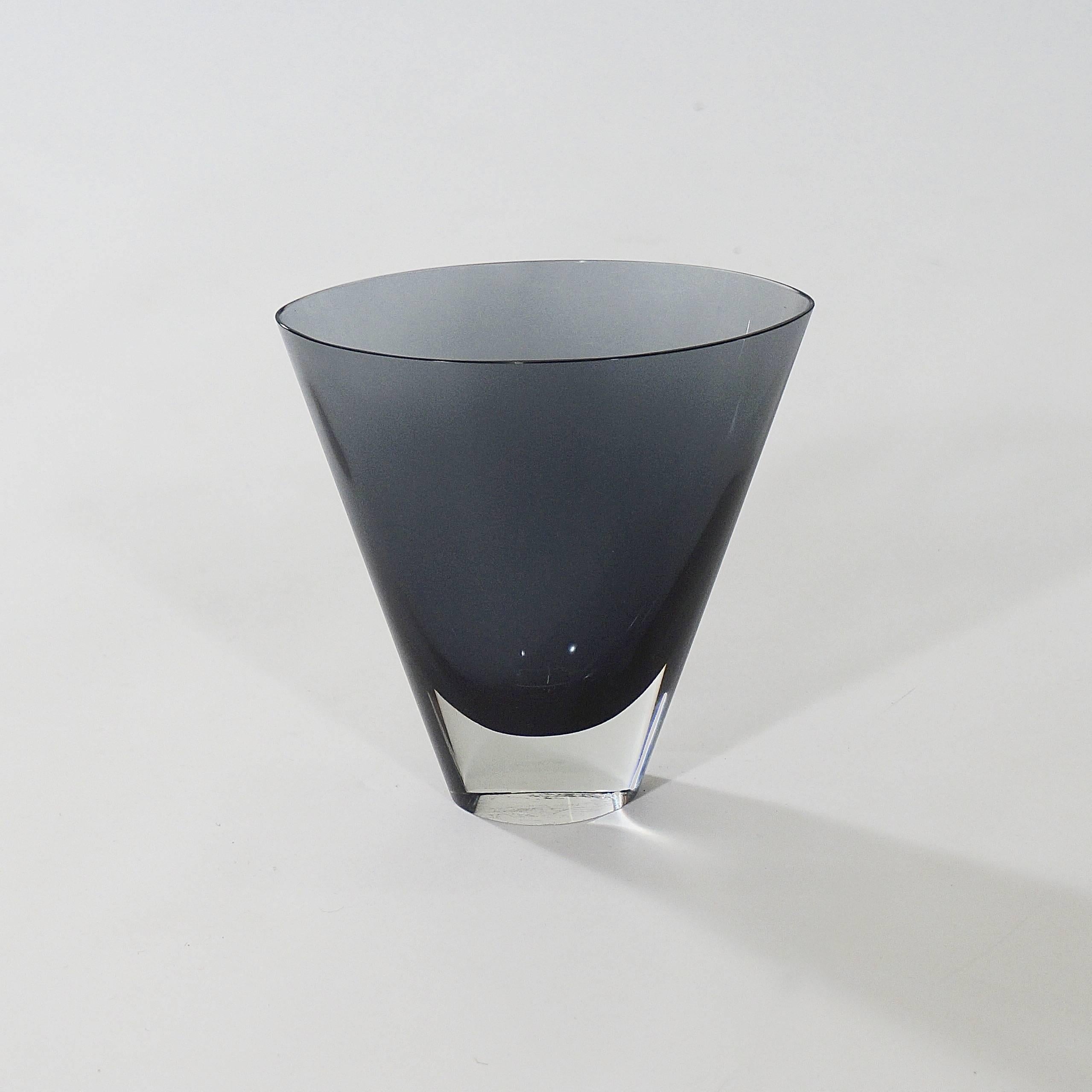 A conical glass vase in midnight blues with clear glass base.

Signed K.Franck Nuutajarvi Notsjo - 56.

Finland, 1956.

An influential figure in Finnish design, the design forum Finland now awards an annual Kaj Franck design prize.