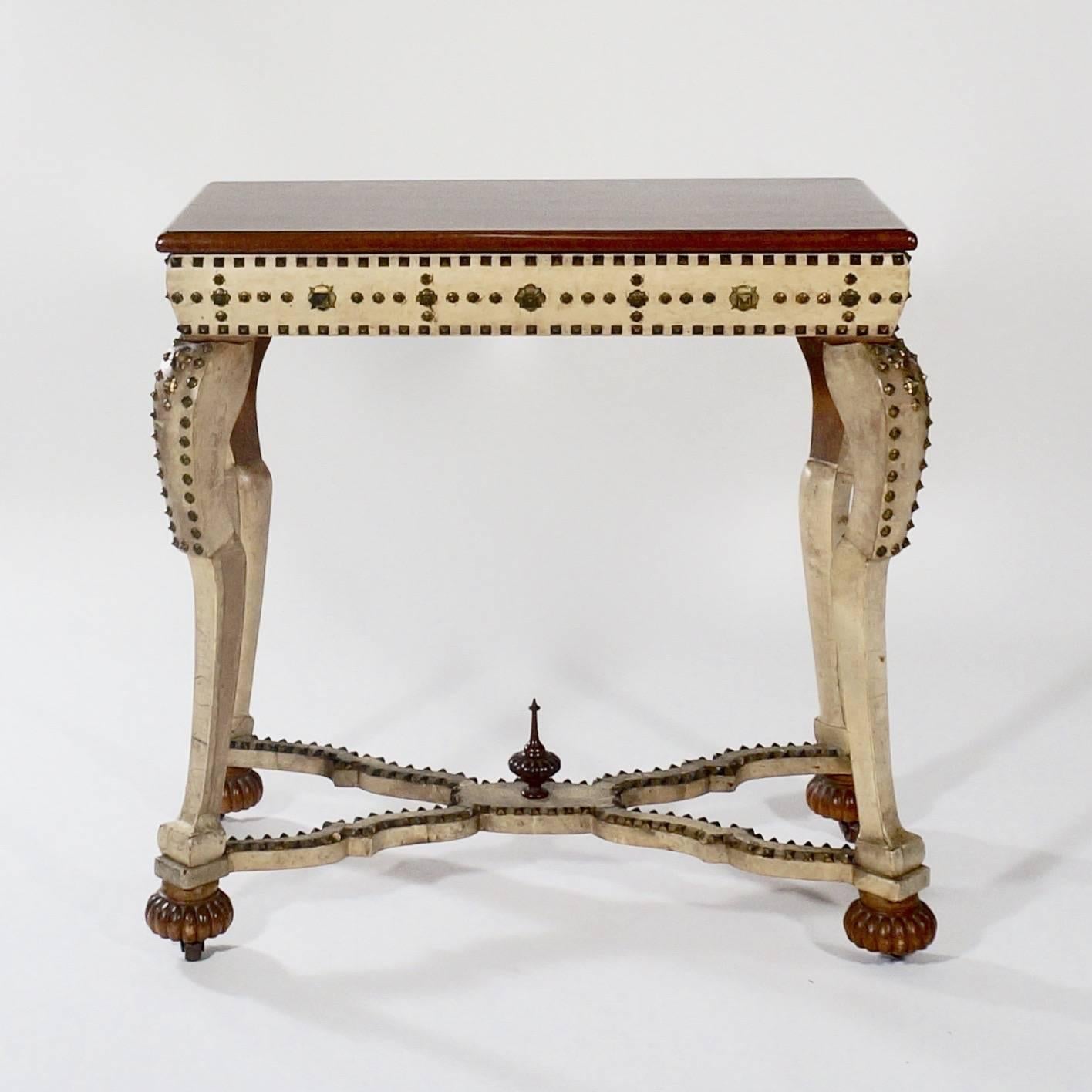 The walnut top above a frieze with decorative stud work supported by ogee legs on gadrooned bun feet joined by cross stretchers supporting a central finial.

Probably Spain, circa 1880s with later elements.