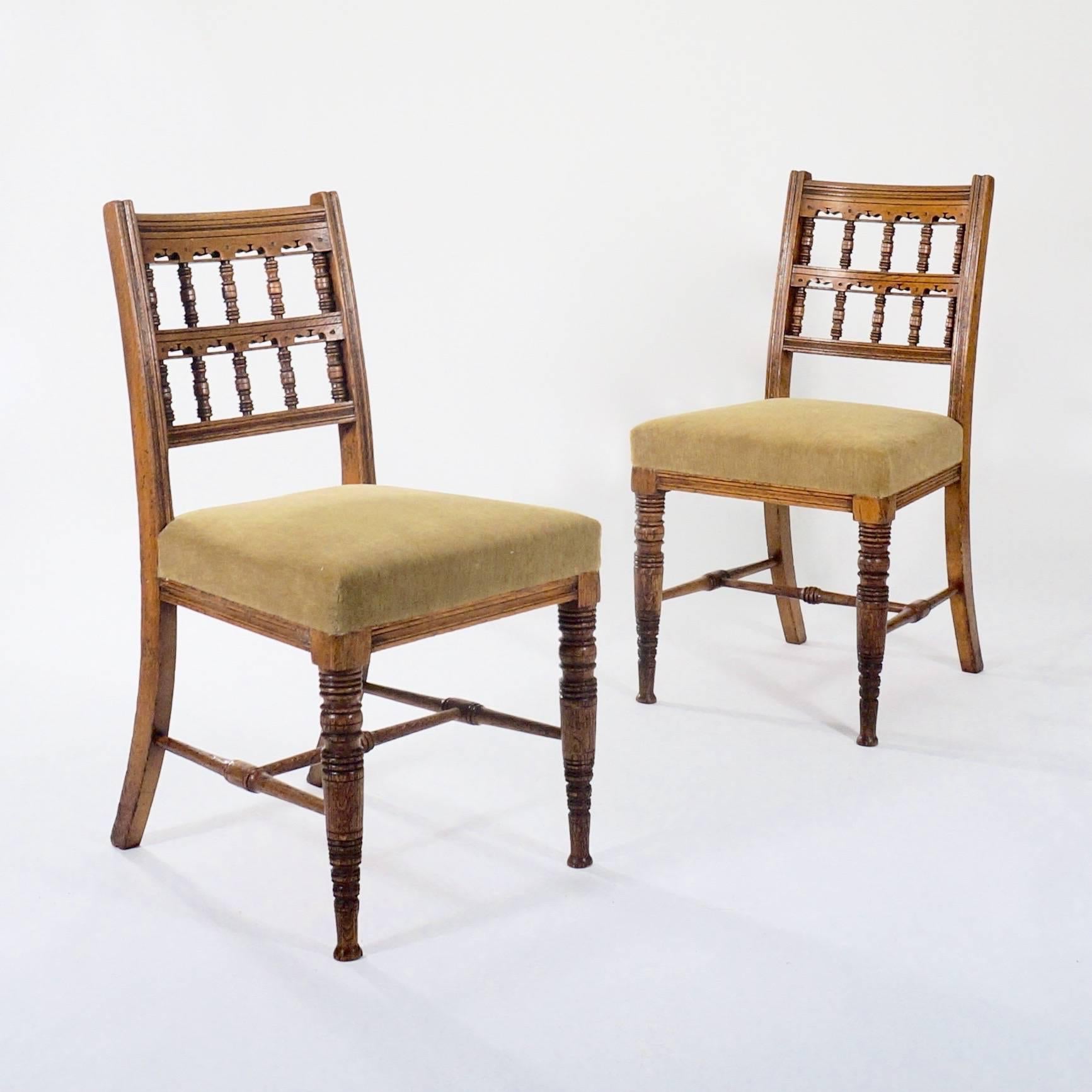 A set of four carved oak side chairs with ring turned supports and upholstered seats.

Probably manufactured by Gillows.

England, circa 1880.