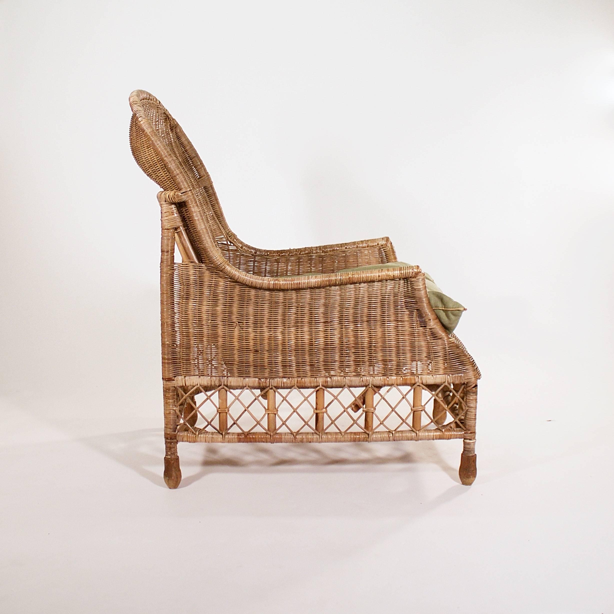 The arched back above splayed arms and a rattan lattice understructure on four turned wood feet.

France, circa 1900s.