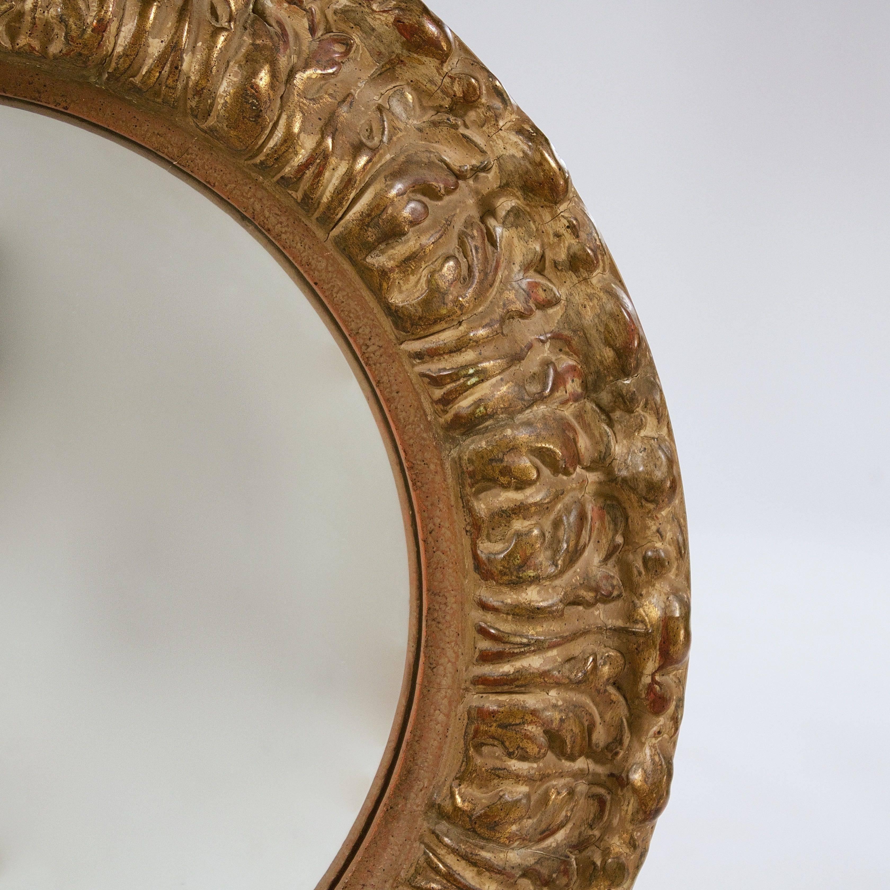The gilded composition frame with acanthus moulded decoration enclosing a later convex plate.

England, circa 1850s.
