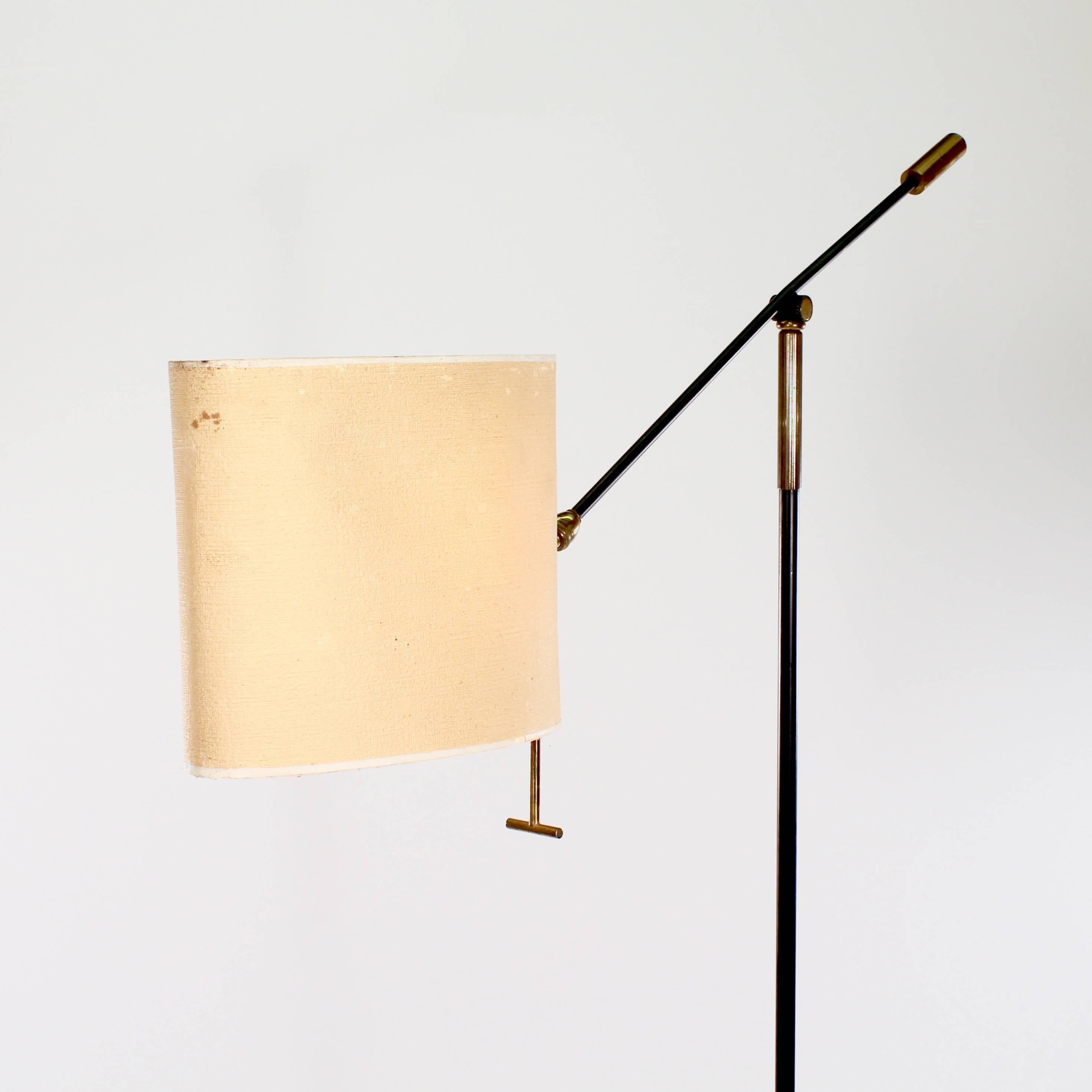 The counterbalanced arm supporting the original adjustable paper shade.

France, circa 1950s

Please note: the paper shade is original and provides a warm light. However, there is a rip to one side (see image). A quote can be provided to