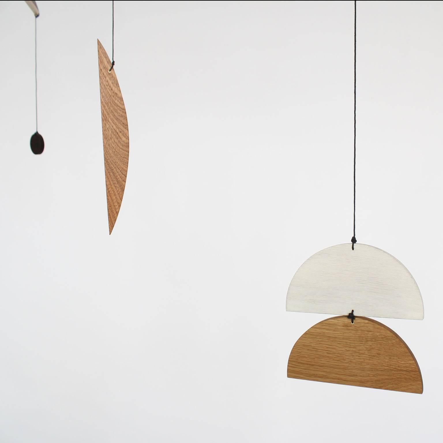 Fort Makers' Circle 1 Mobile is made in Brooklyn by Noah Spencer. His wooden kinetic sculptures explore organic and linear form and touch upon a human fascination with the universe.

Materials: pine, white oak, maple, sapele, wenge, wax string with