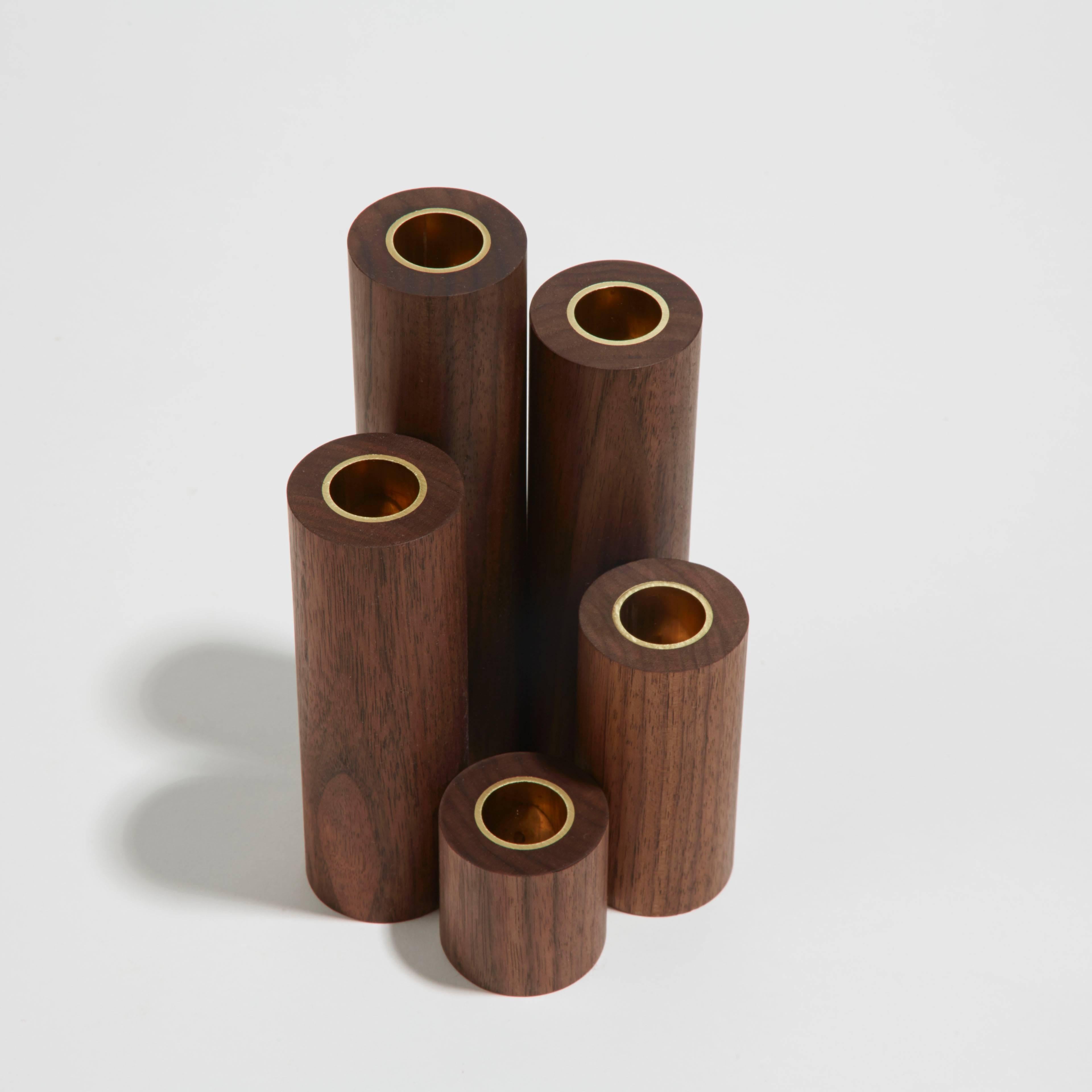 Candlestick City is a project inspired by early 20th century toy design. Noah Spencer's candlestick sets playfully explore geometry and varieties of wood species. Like building blocks, each piece in the architectural set can be arranged in multiple