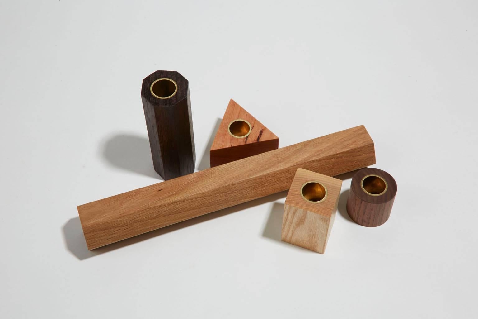 Candlestick City is a project inspired by early 20th century toy design. Noah Spencer's candlestick sets playfully explore geometry and varieties of wood species. Like building blocks, each piece in the architectural set can be arranged in multiple