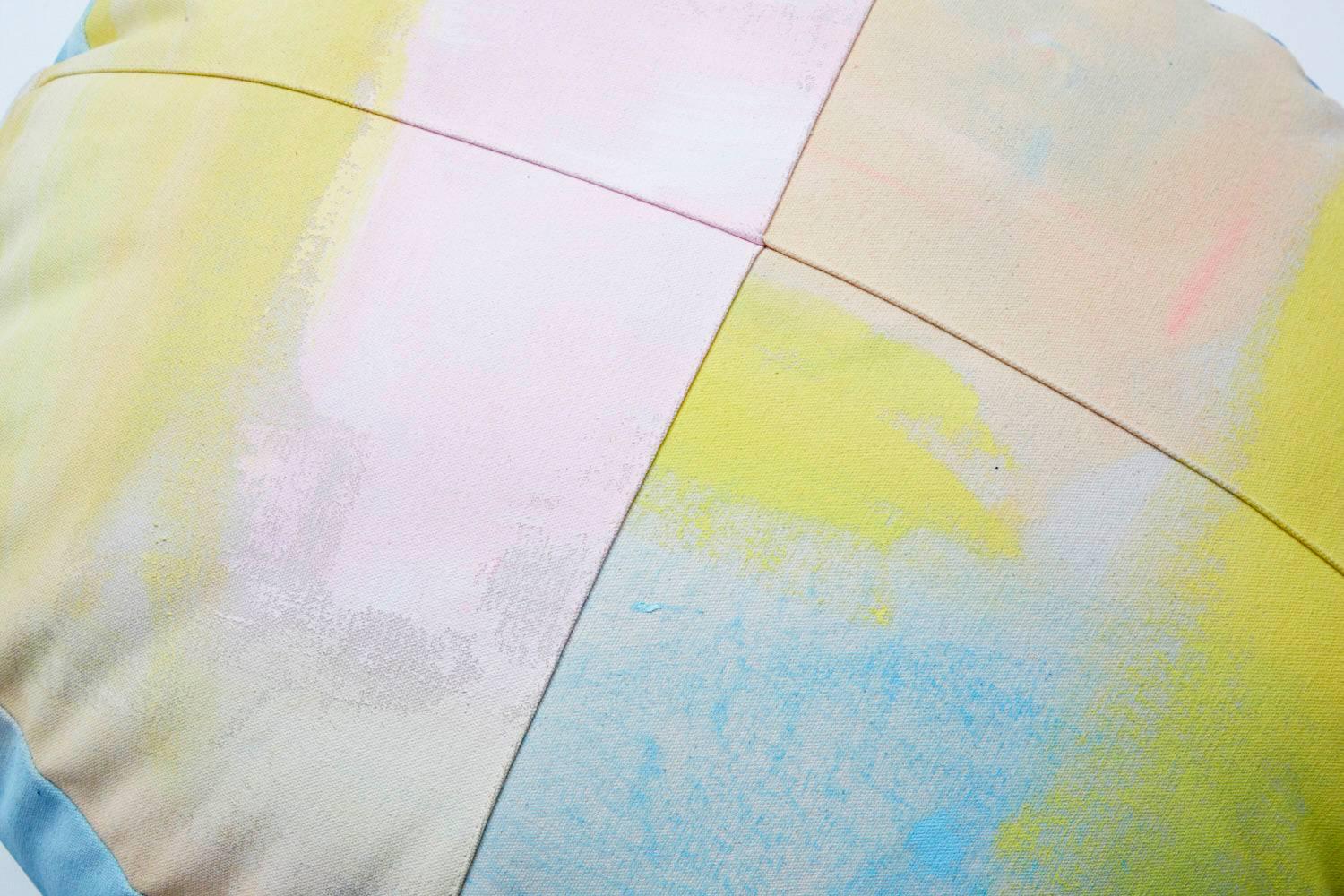 For Fort Makers, Naomi Clark paints vibrant abstract compositions on fabrics that are then made into useable objects. Each hand-painted cotton canvas circular ottoman is a completely unique piece of art and can be customized according to customers'