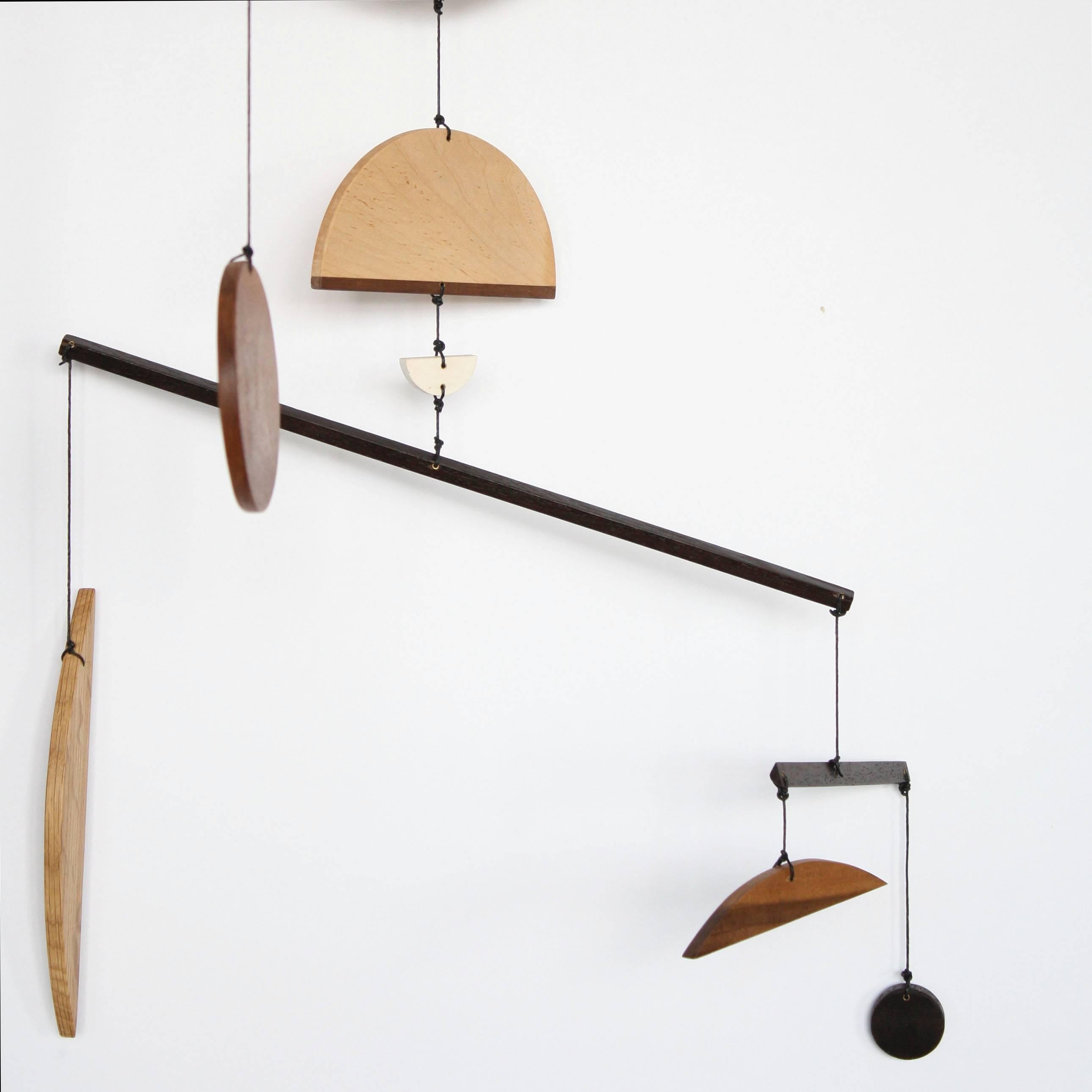 Fort Makers' Circle Two Mobile is made in Brooklyn by Noah Spencer. His wooden kinetic sculptures explore organic and linear form and touch upon a human fascination with the universe.

Materials: pine, white oak, maple, sapele, wenge, wax string
