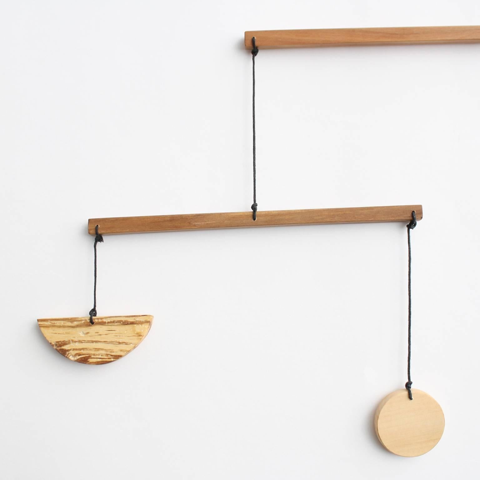 Fort Makers' Medium Apple A Mobile is made in Brooklyn by Noah Spencer. His wooden kinetic sculptures explore organic and linear form and touch upon a human fascination with the universe.

Materials: apple wood, wax string with end loop for hanging