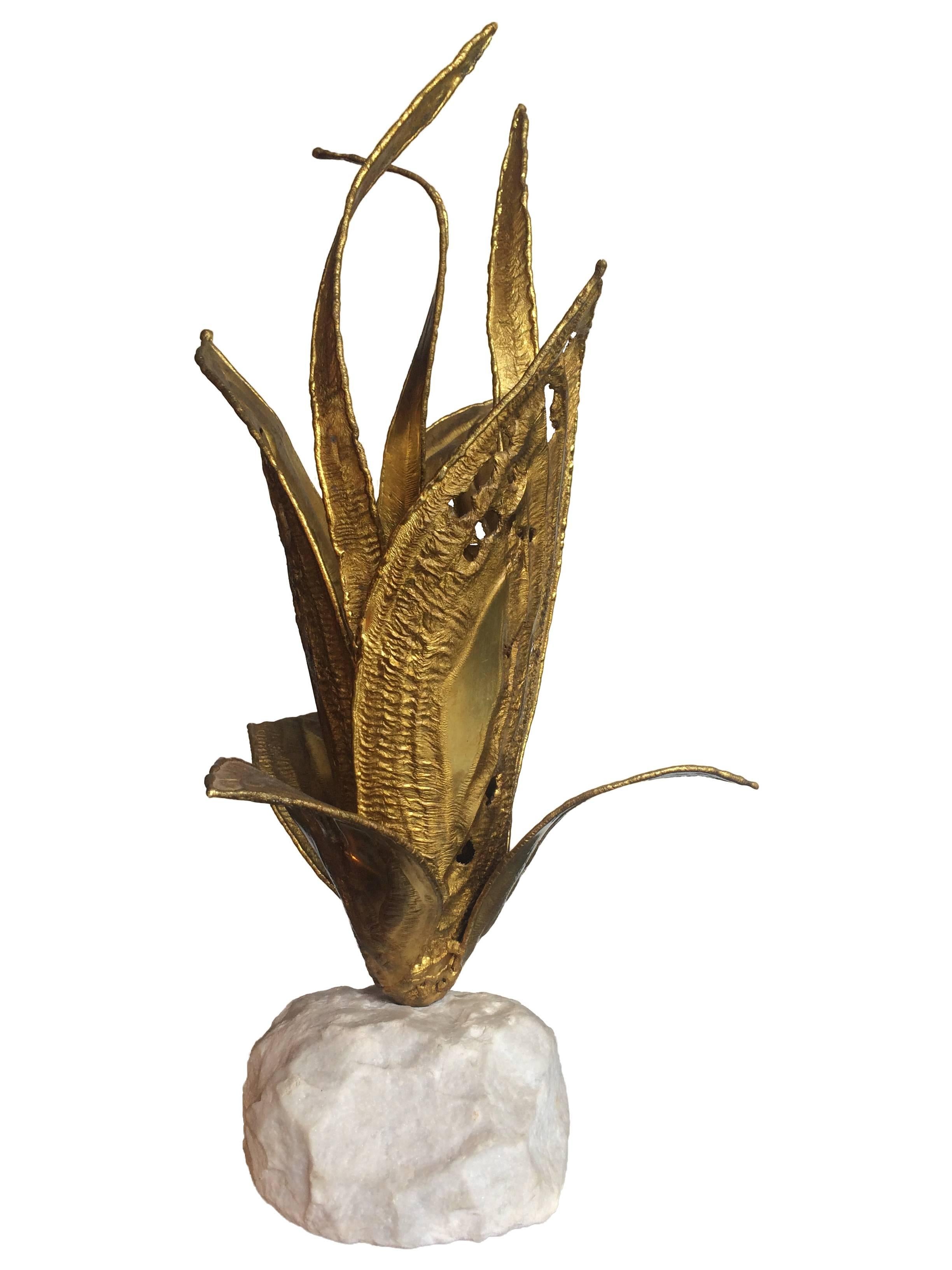 A Jaques Duval Brasseur torch-cut brass flower lamp on solid rough cut white marble base. The lamp has one central fitting in the leaves and has been rewired with antique gold cord flex and PAT tested.