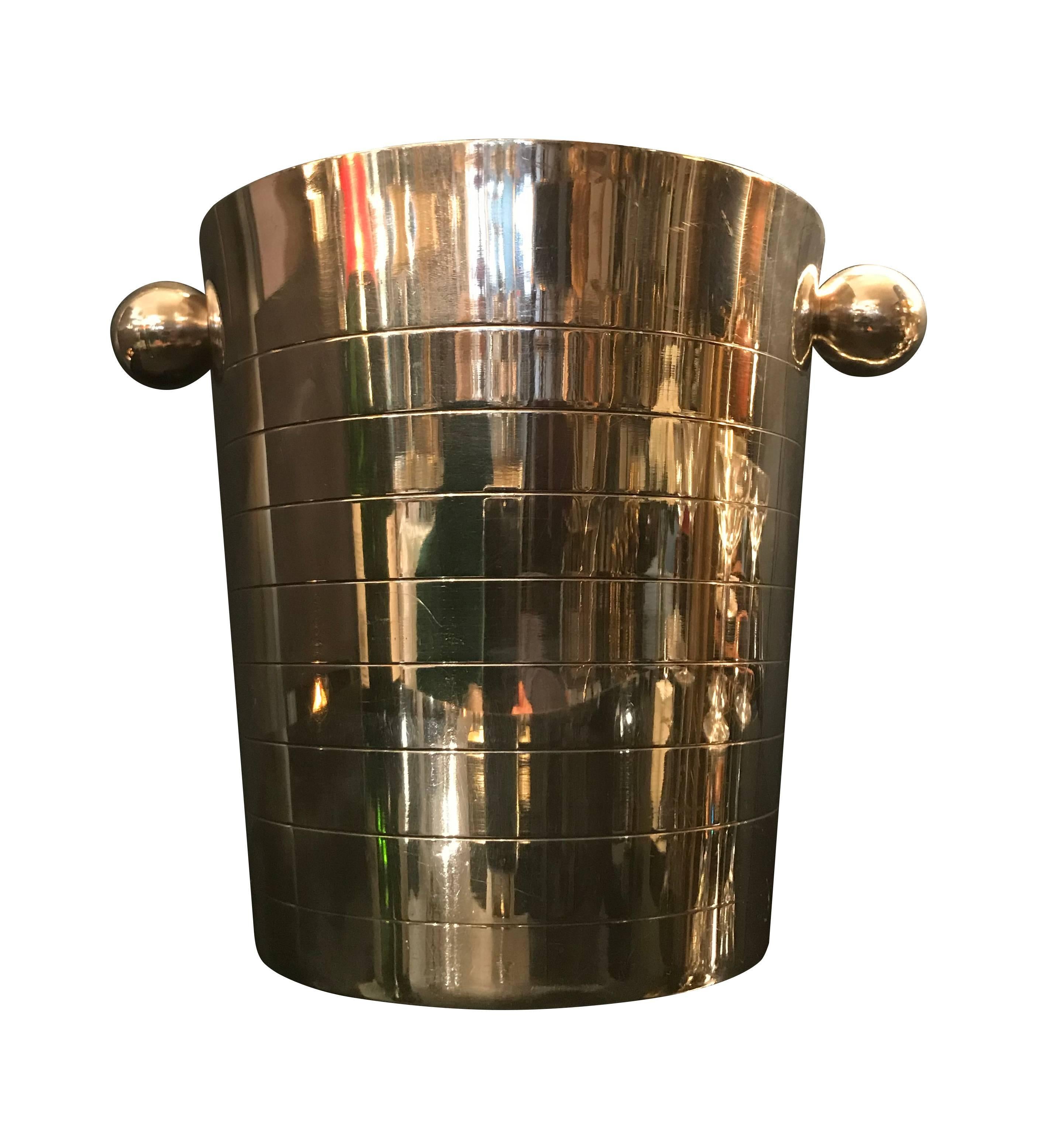 An Art Deco style silver plated ice bucket with clean design of concentric lines and ball handles.